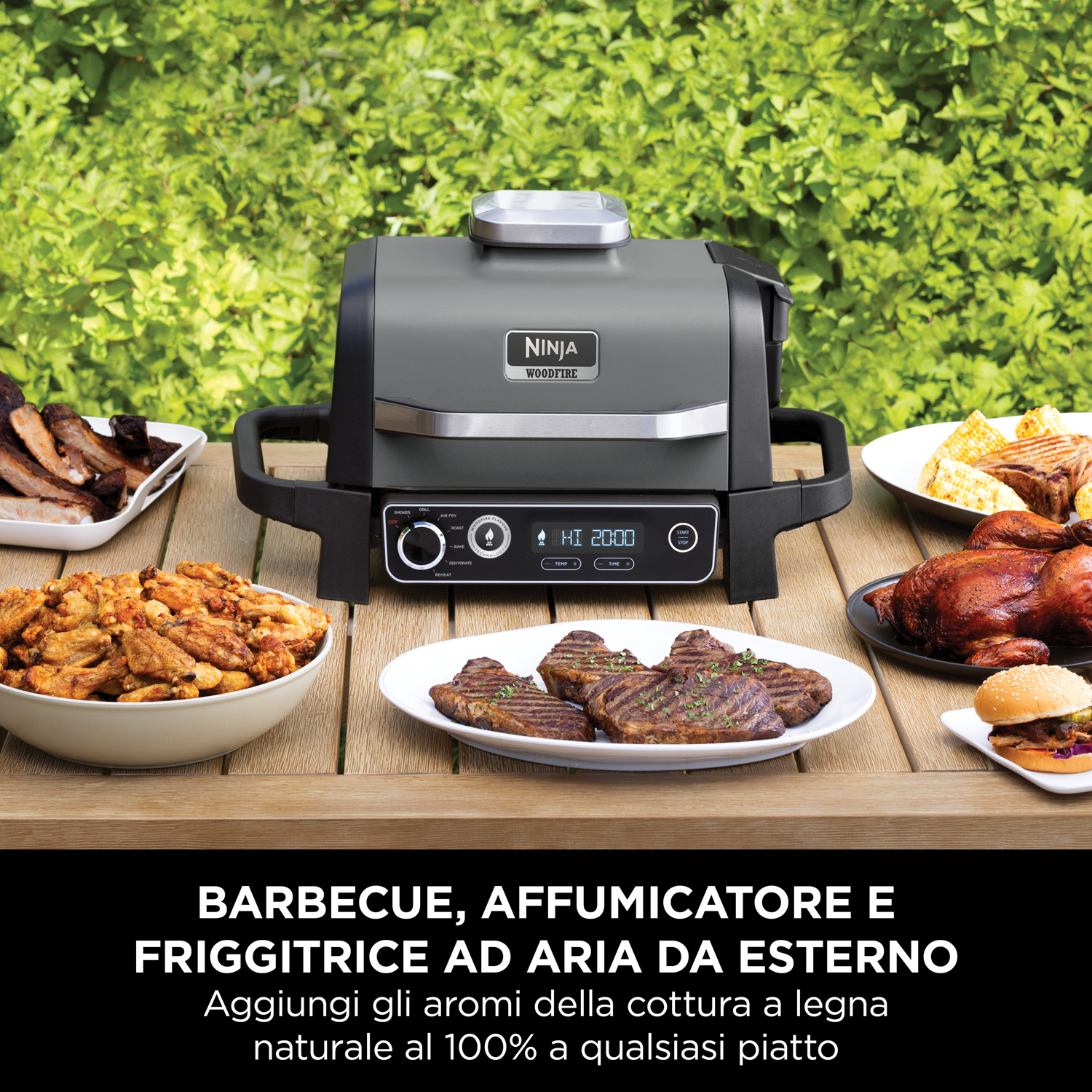 Un Ninja Woodfire Grill con cibo cotto su un tavolo. Lo sfondo è un cespuglio verde.