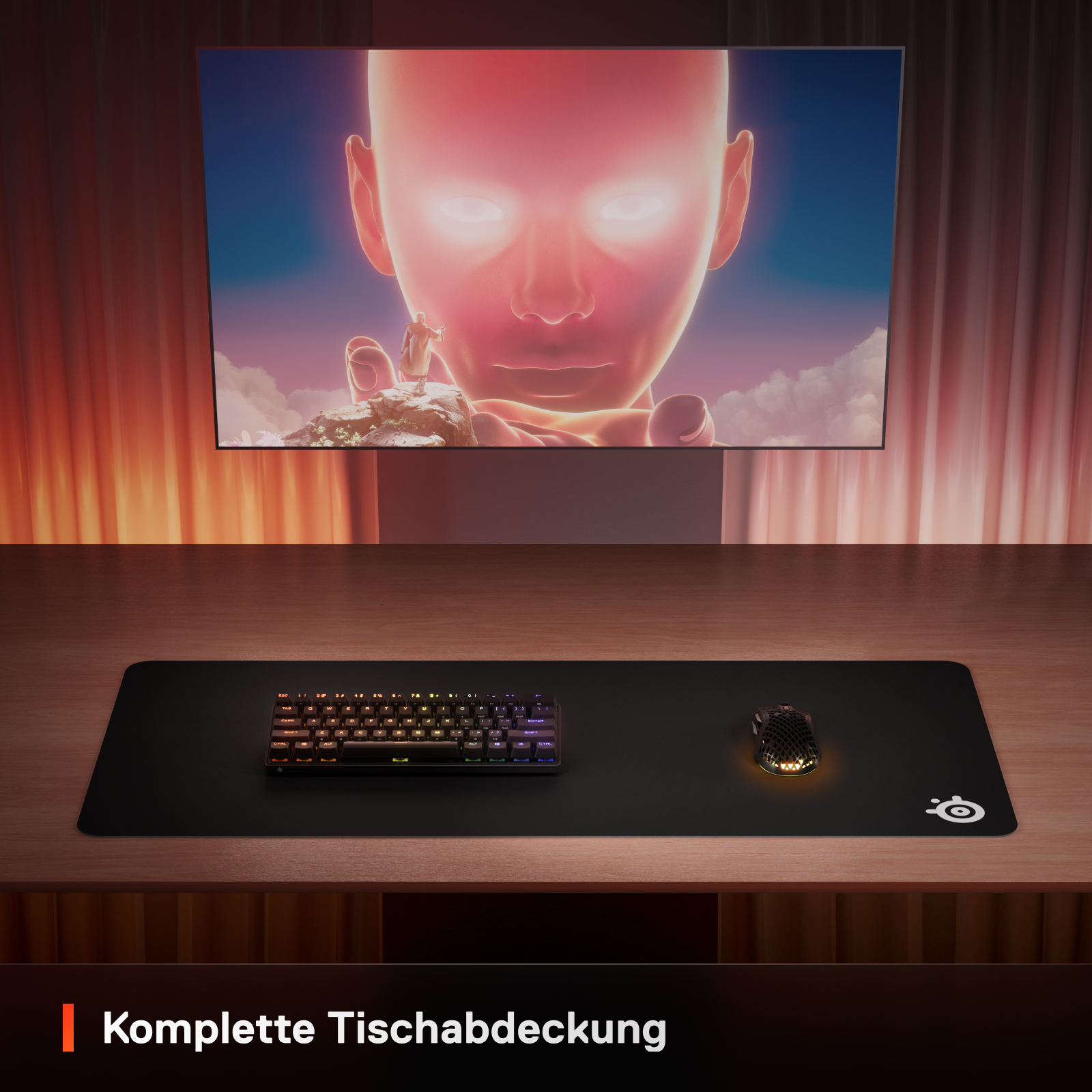Ein Schreibtisch mit Tastatur, Maus und großem Bildschirm mit menschlichem Gesicht.