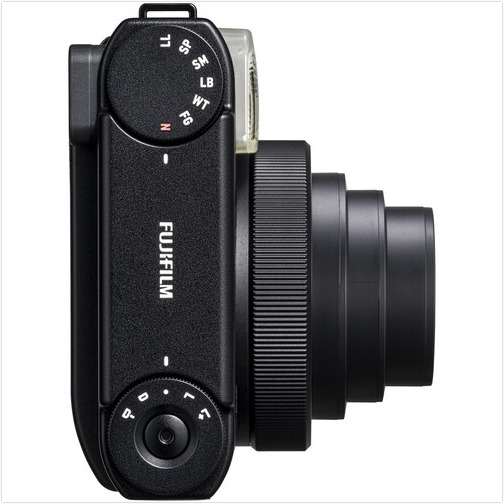Black camera from the top, showing lens and controls. Fujifilm logo is visible.