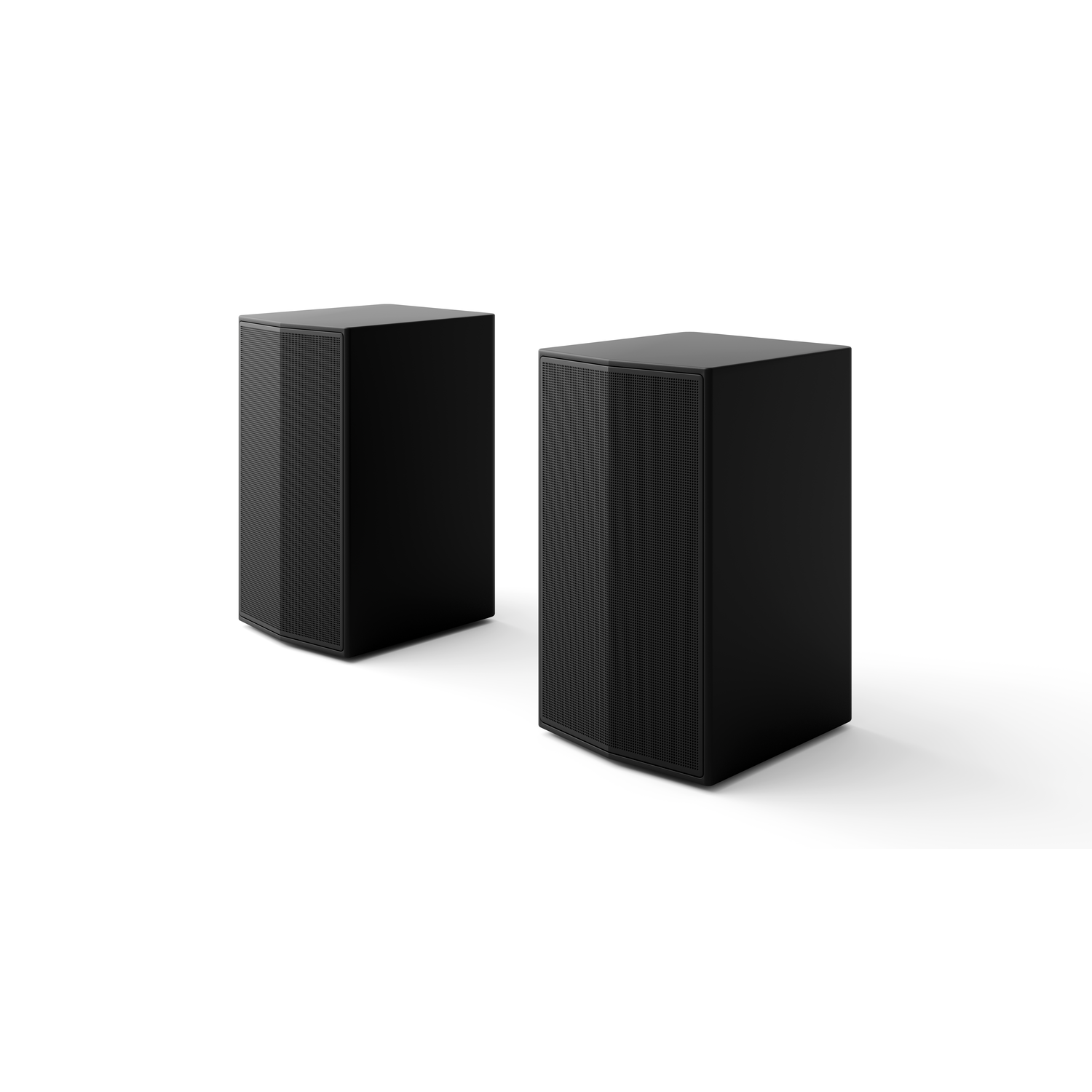 Two black speakers on a white surface, side by side.