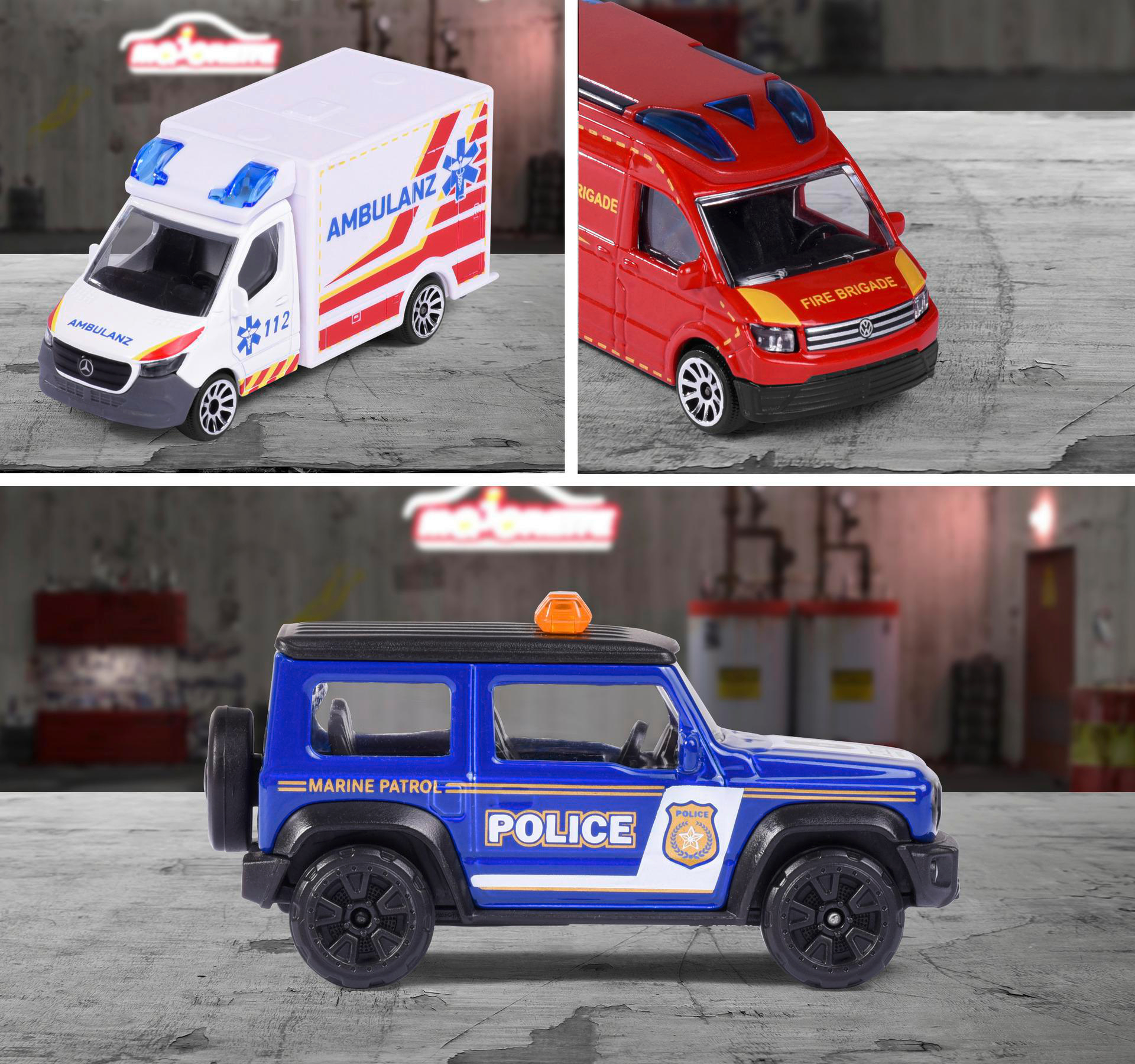 Spielzeug-Notfallfahrzeuge. Ein Krankenwagen, ein Feuerwehrauto und ein Polizei-Jeep stehen auf grauem Untergrund.