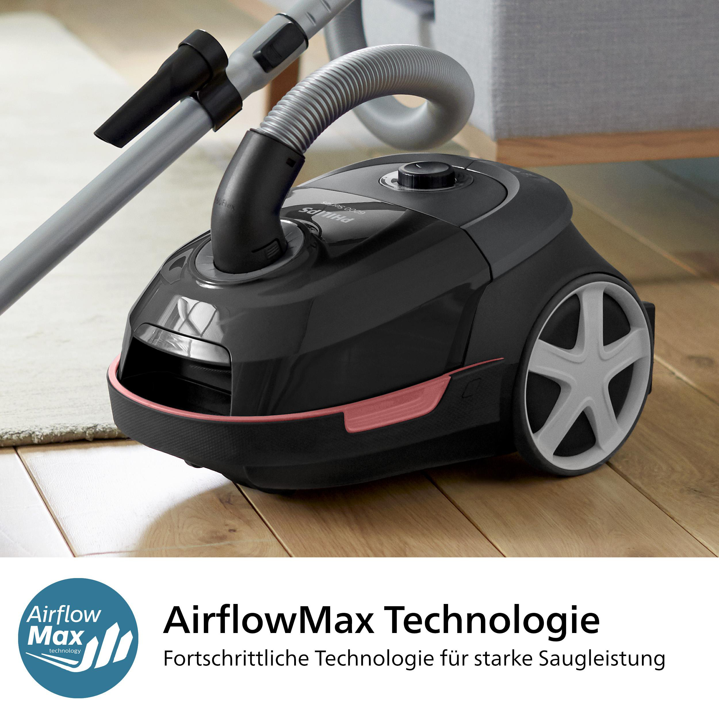 Schwarzer Staubsauger mit AirflowMax Technologie, schräge Ansicht, auf Holzboden.