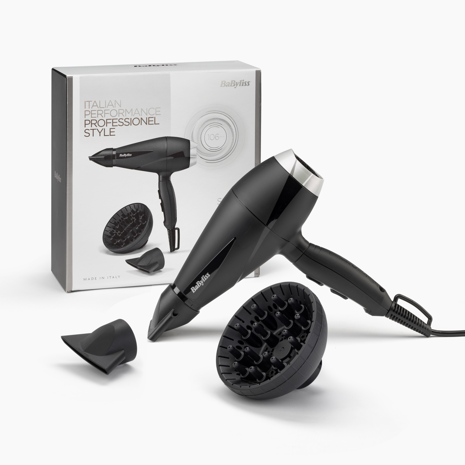 Black hairdryer with attachments and box, on white background.