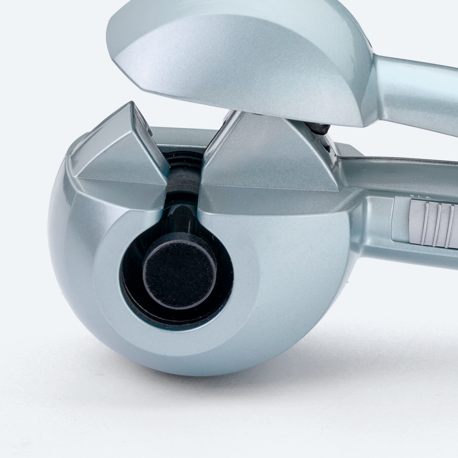 A close-up of a light blue hair curler, showing the curling mechanism.
