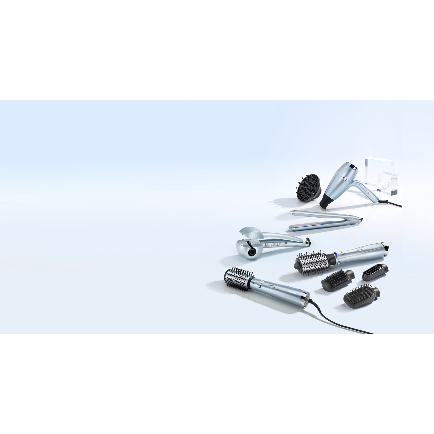 Hair styling tools: hair dryer, straightener, curling iron, brushes, on blue background.