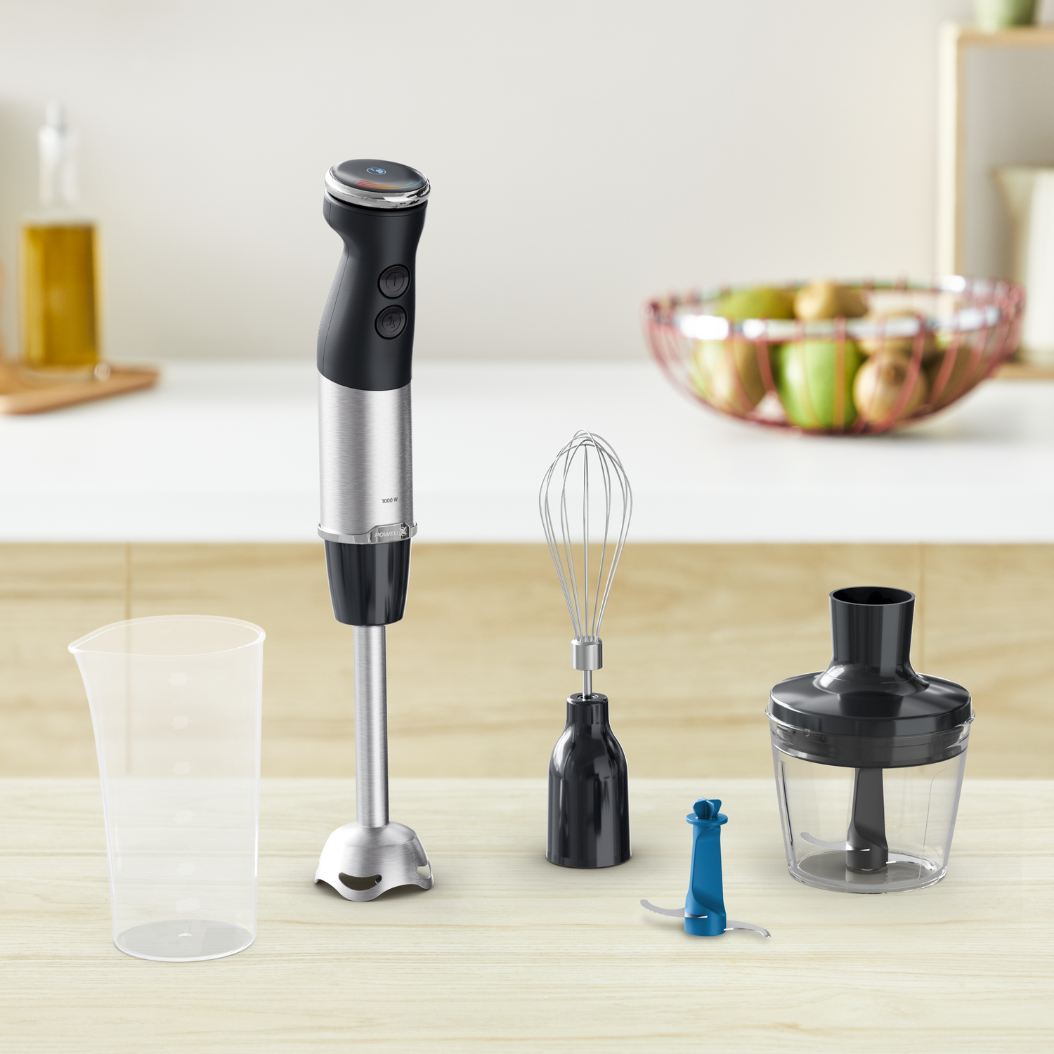 An immersion blender with attachments on a wooden table. Bowl of fruit in the background.