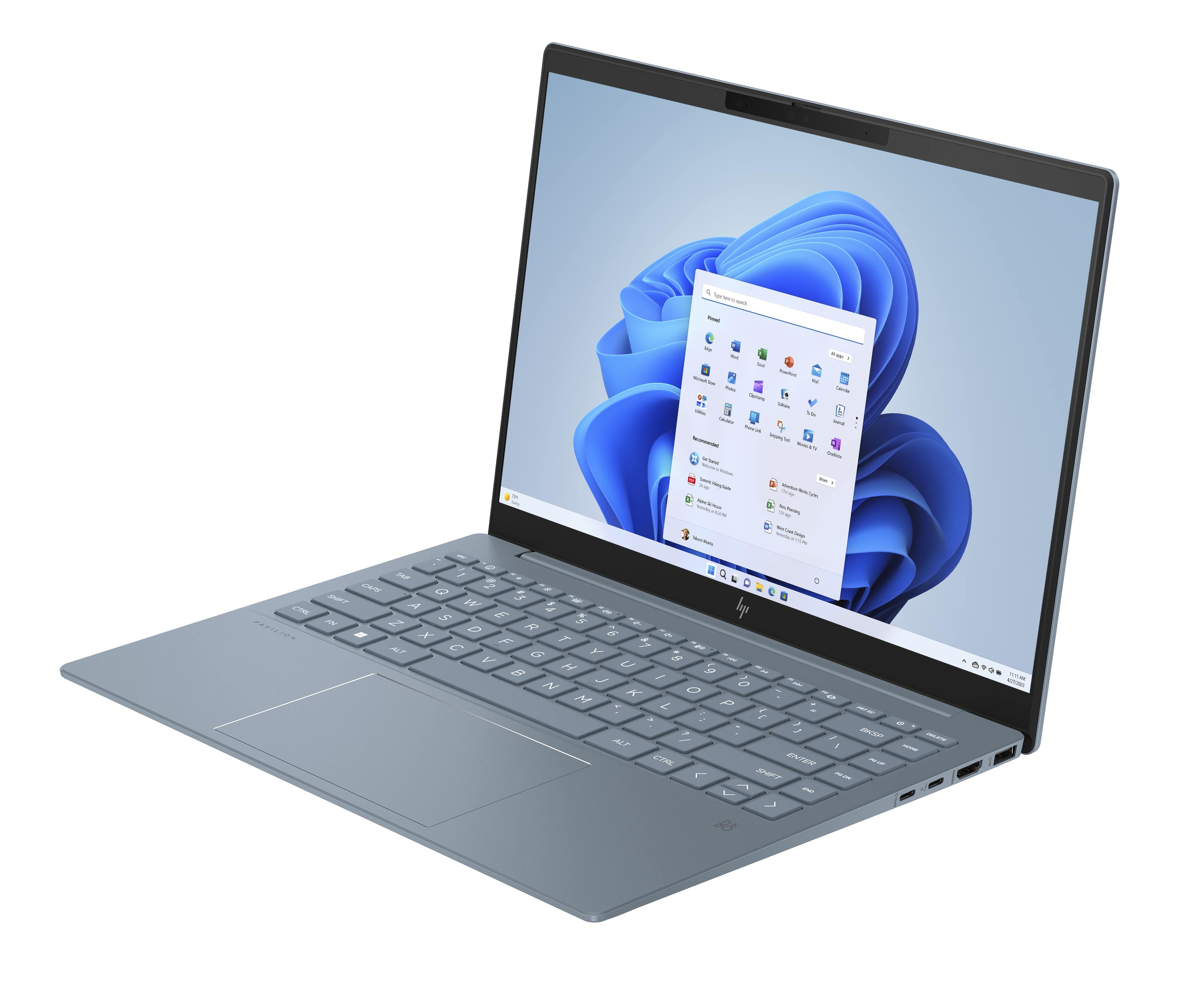 Laptop azul abierto, mostrando interfaz Windows 11 con iconos de aplicaciones en superficie blanca.