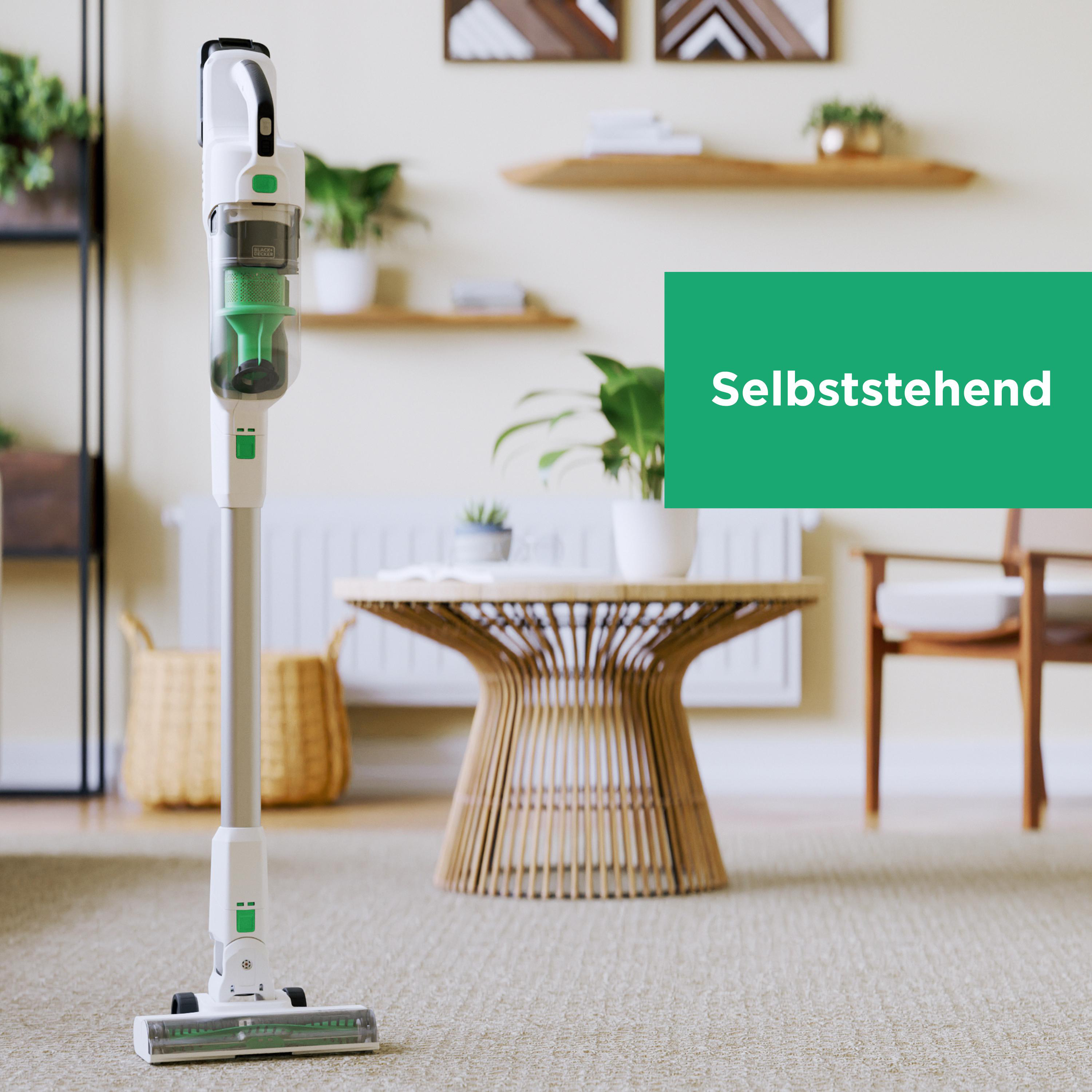 Staubsauger auf einem Teppich in einem Wohnzimmer. Text auf dem Bild lautet 'Selbststehend'.