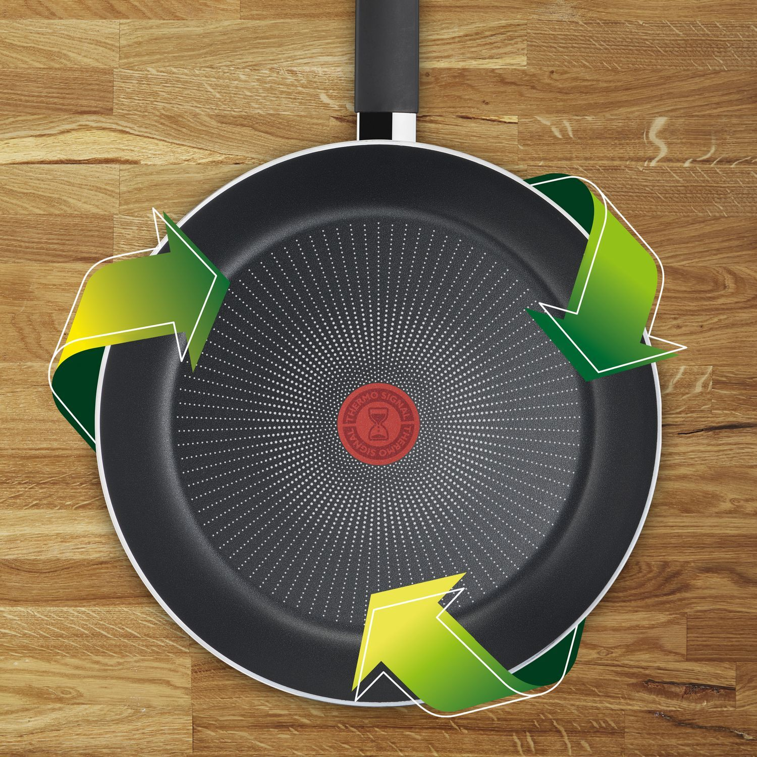Tefal pan bottom with arrows indicating heat. Red circle in the center.
