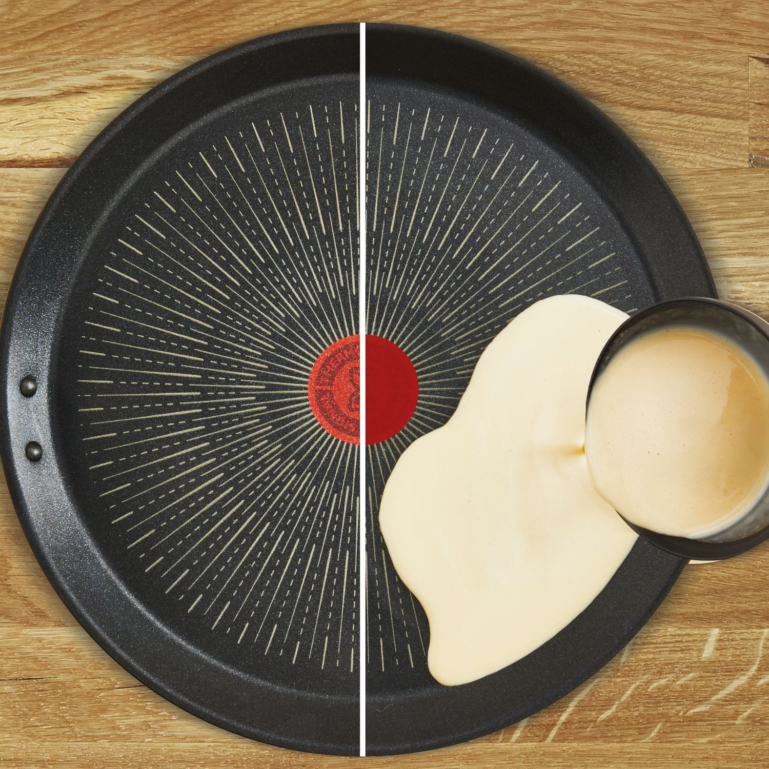 A frying pan with pancake batter being poured into it. The pan is red in the center.