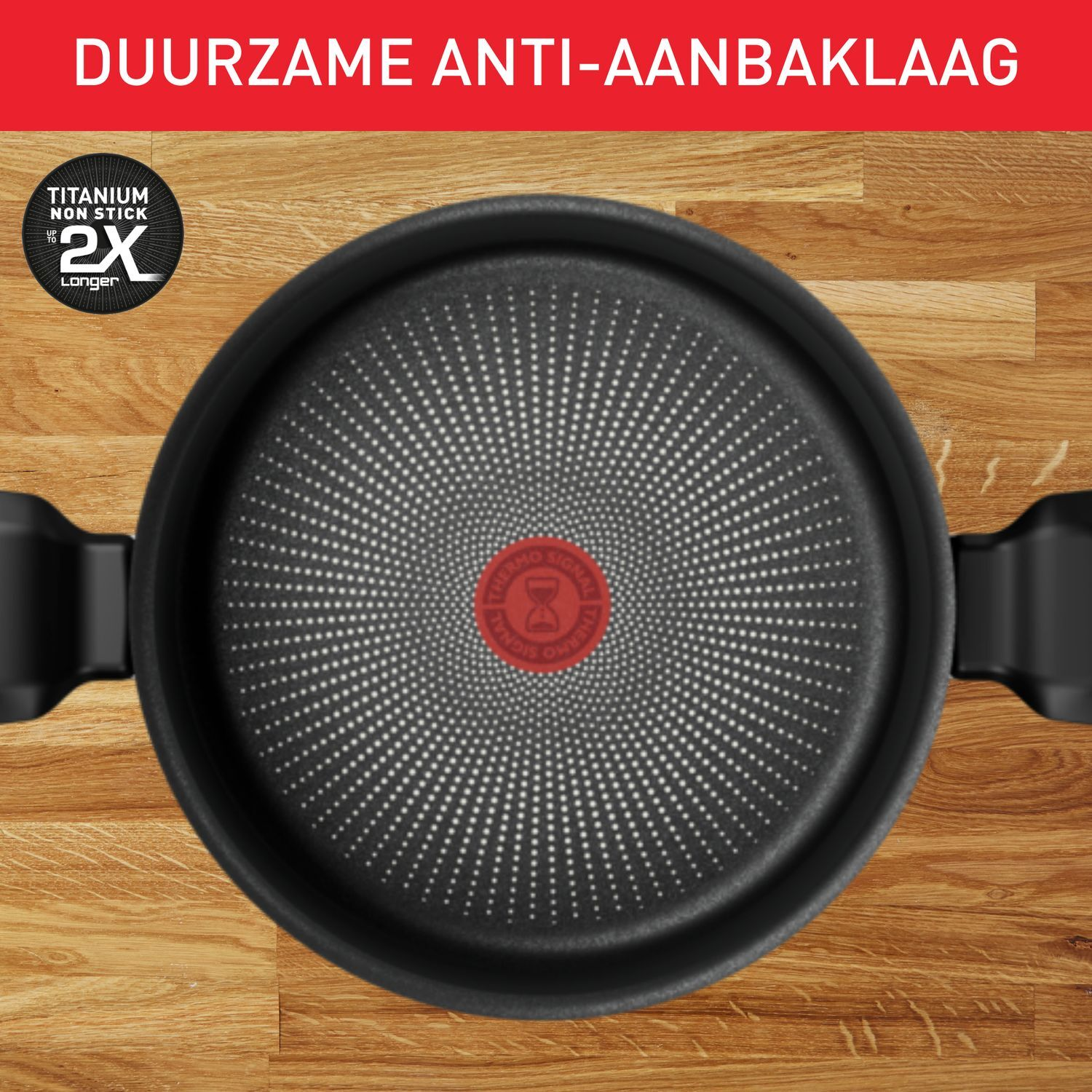 A black frying pan on a wooden surface, with a red circle in the center.