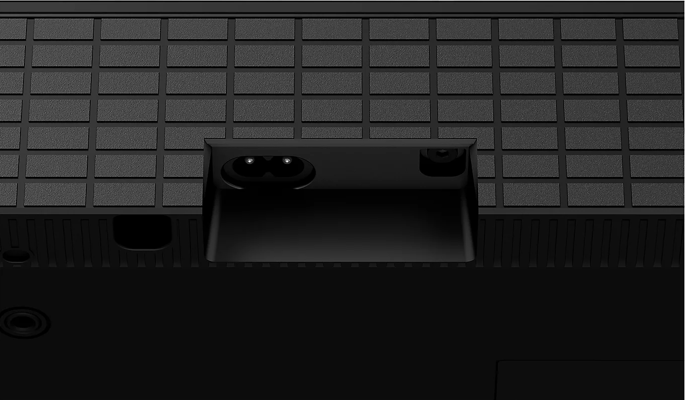 Tył czarnego telewizora z wejściem zasilania i innymi portami.