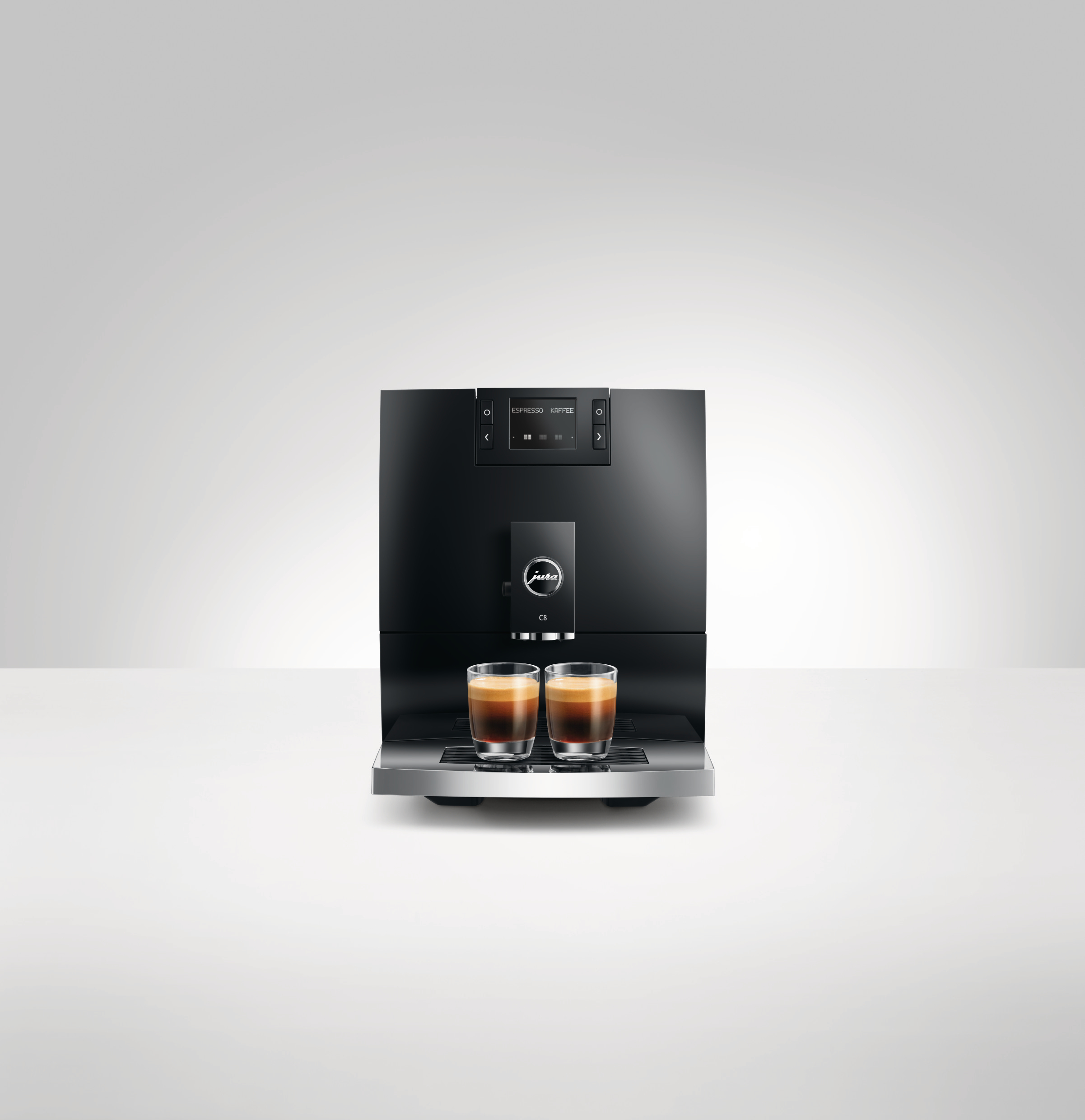 Schwarze Kaffeemaschine mit zwei Tassen Espresso.