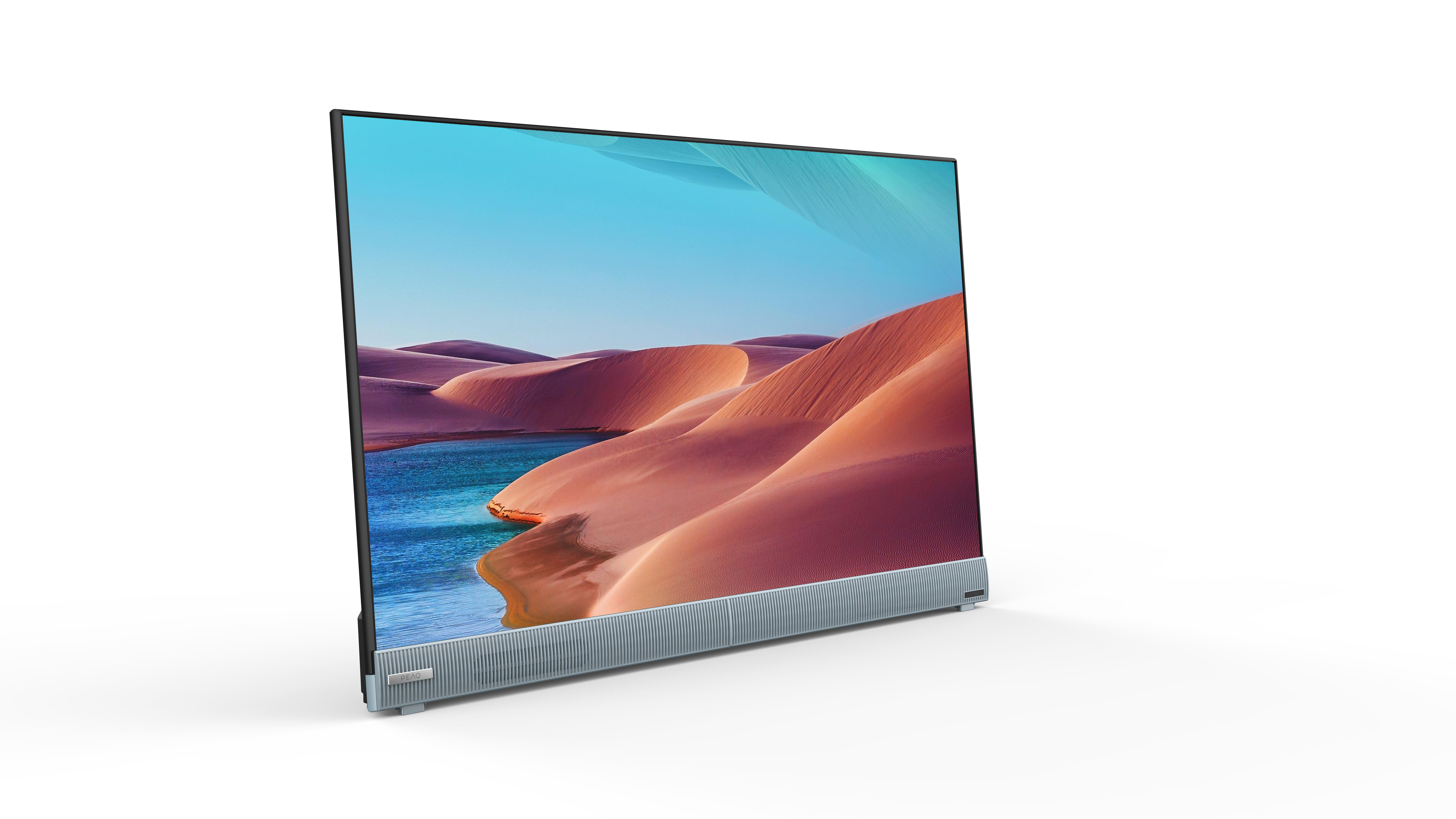 Ein moderner Fernseher mit einem Bildschirm, der eine Wüstenlandschaft mit Dünen und blauem Himmel zeigt.