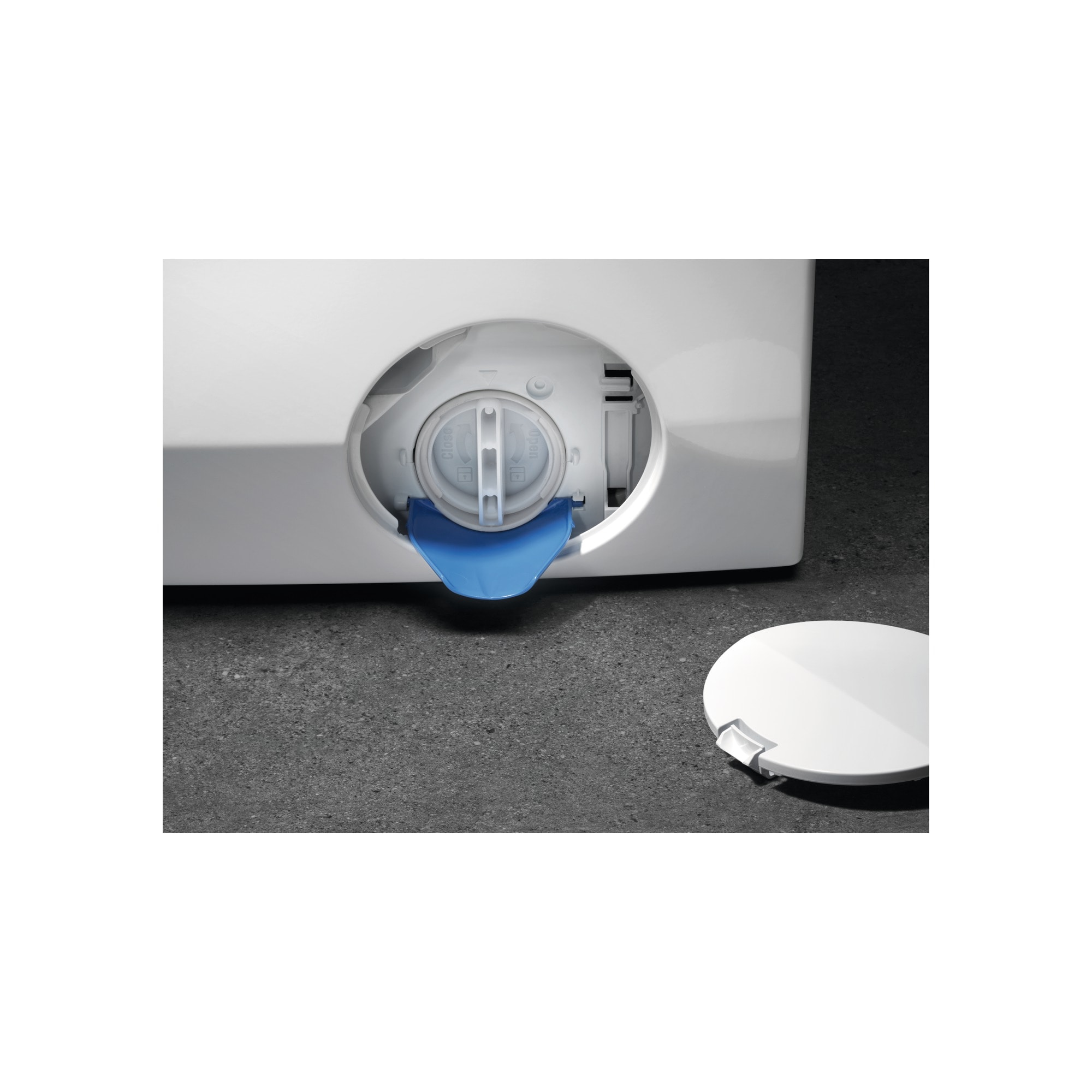 Close-up of a white washing machine's detergent compartment with blue plastic and a white lid.