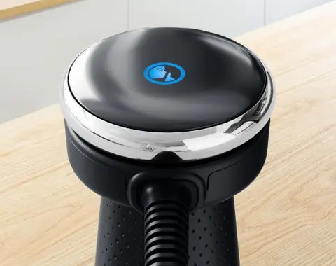 Czarne urządzenie ze srebrnym pierścieniem i niebieską ikoną na górze.