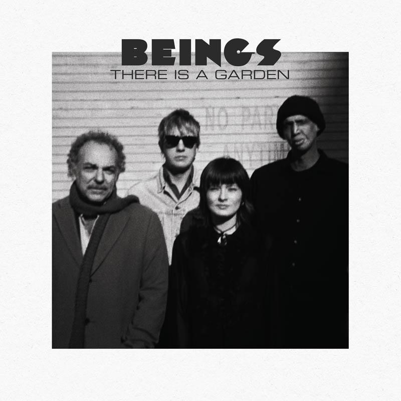 Schwarz-Weiß-Foto einer Band, 'BEINGS', mit dem Text 'THERE IS A GARDEN' über ihnen.