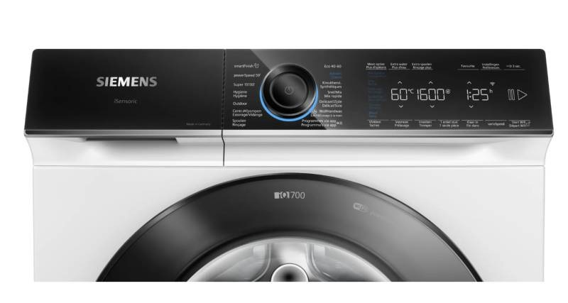 Gros plan sur le panneau de commande d'un lave-linge noir et blanc.
