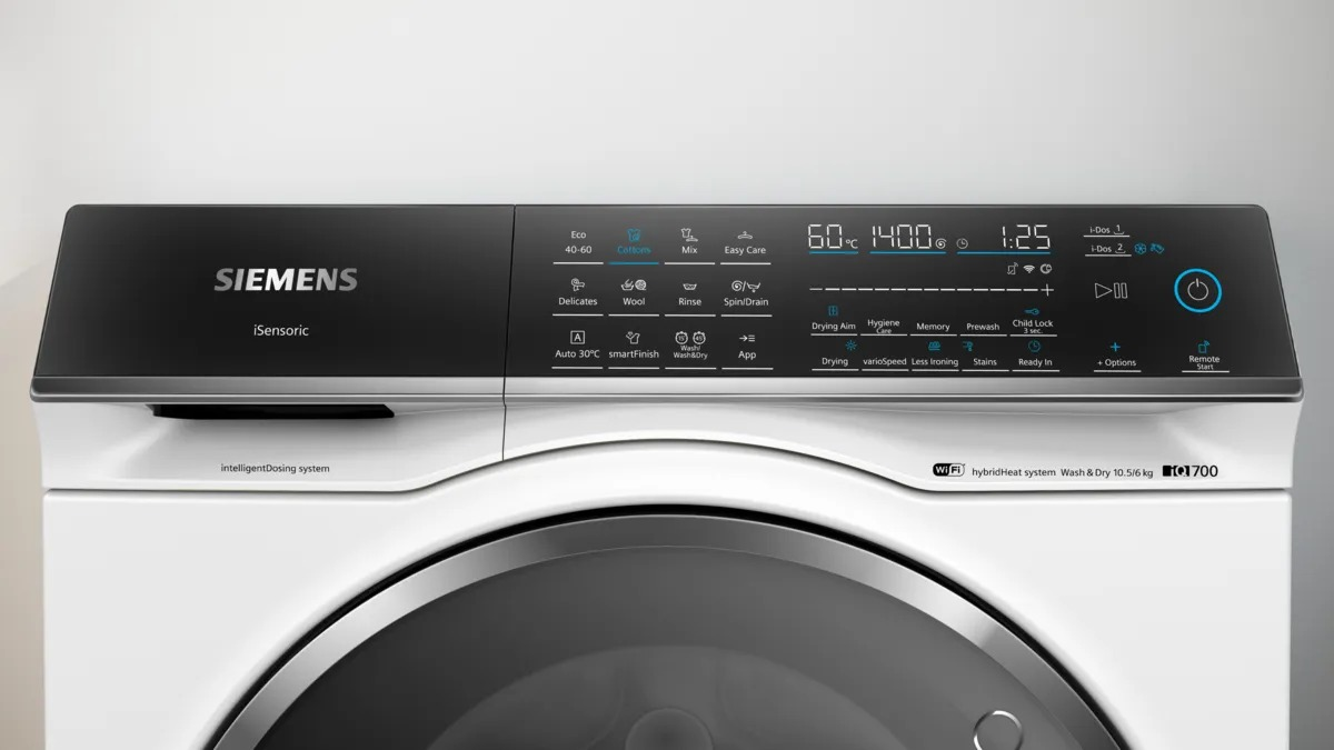 Close-up of a white Siemens washing machine control panel with buttons and a display.