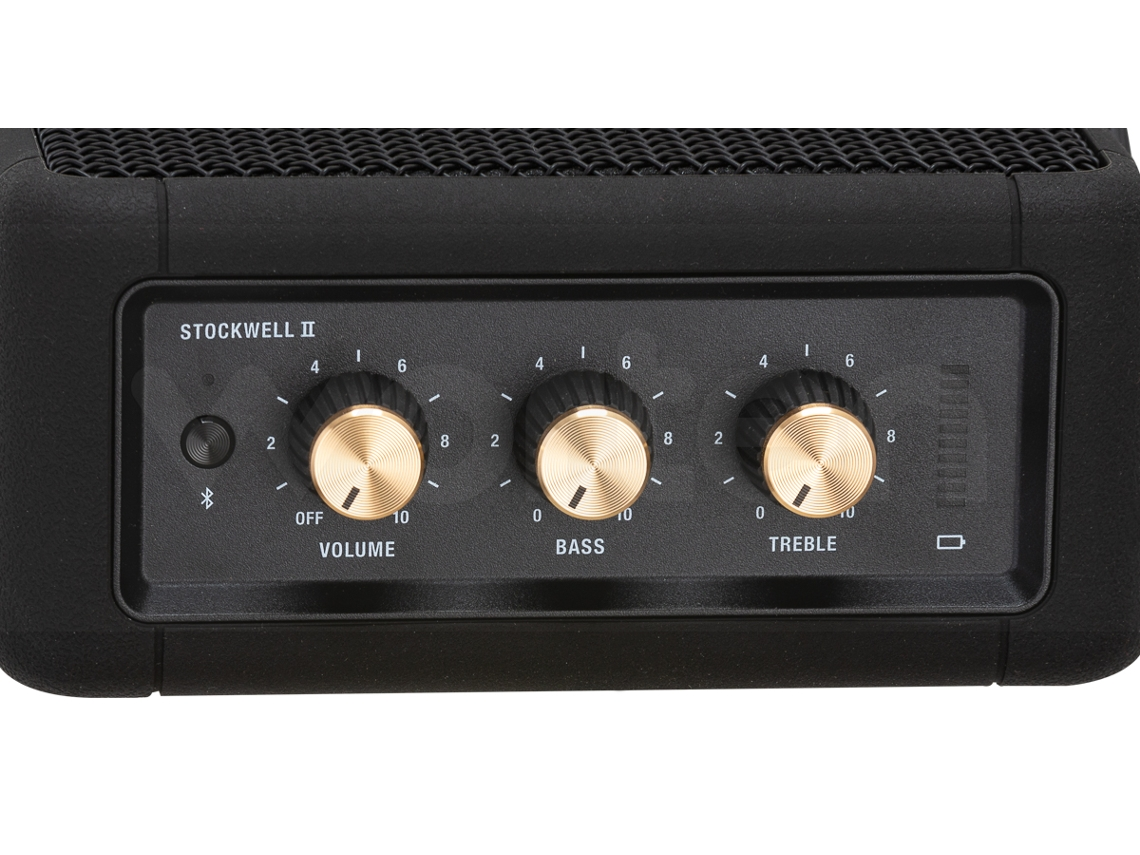 Altavoz de audio negro con tres perillas doradas para volumen, bajos y agudos.