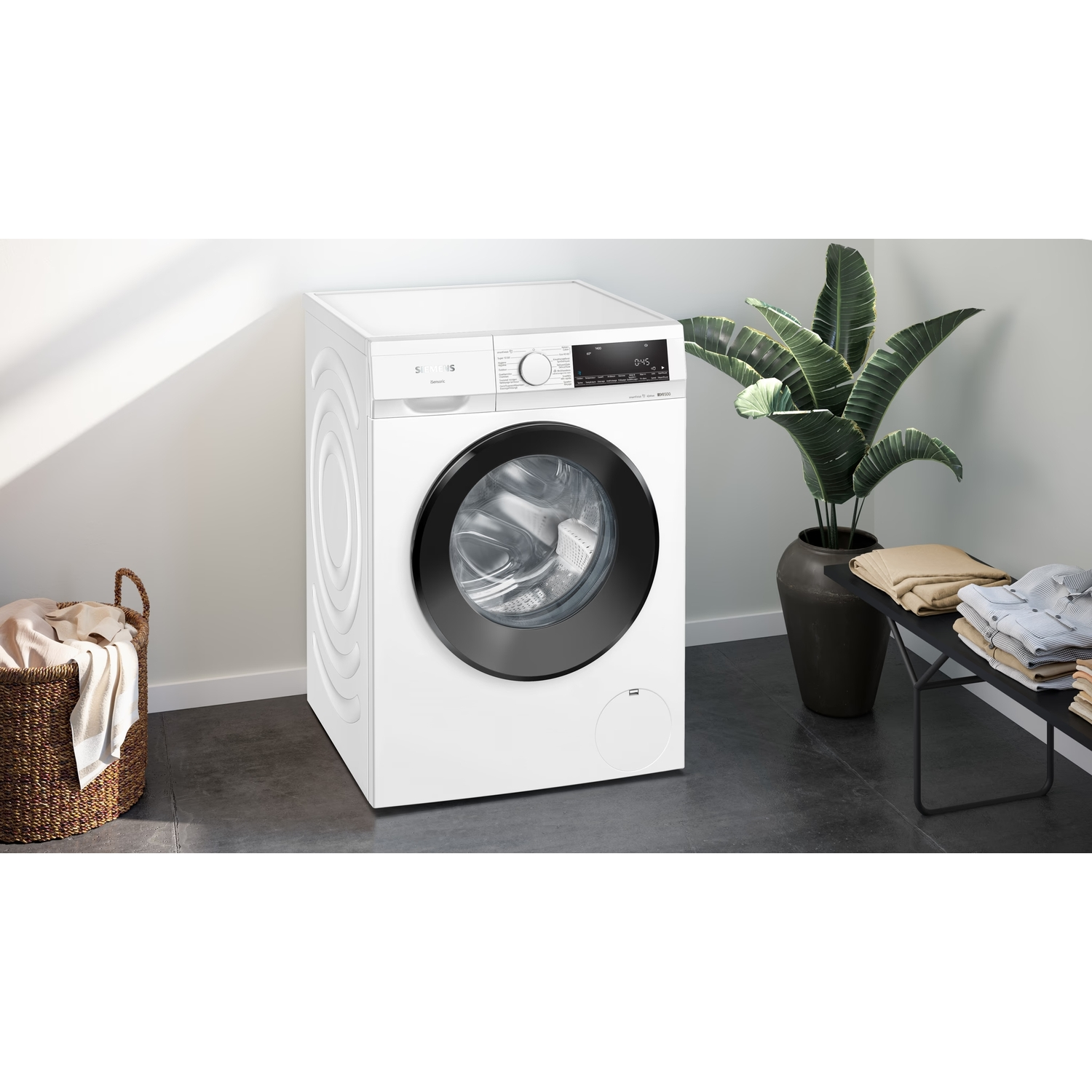 A white washing machine with a black door and a basket of clothes.