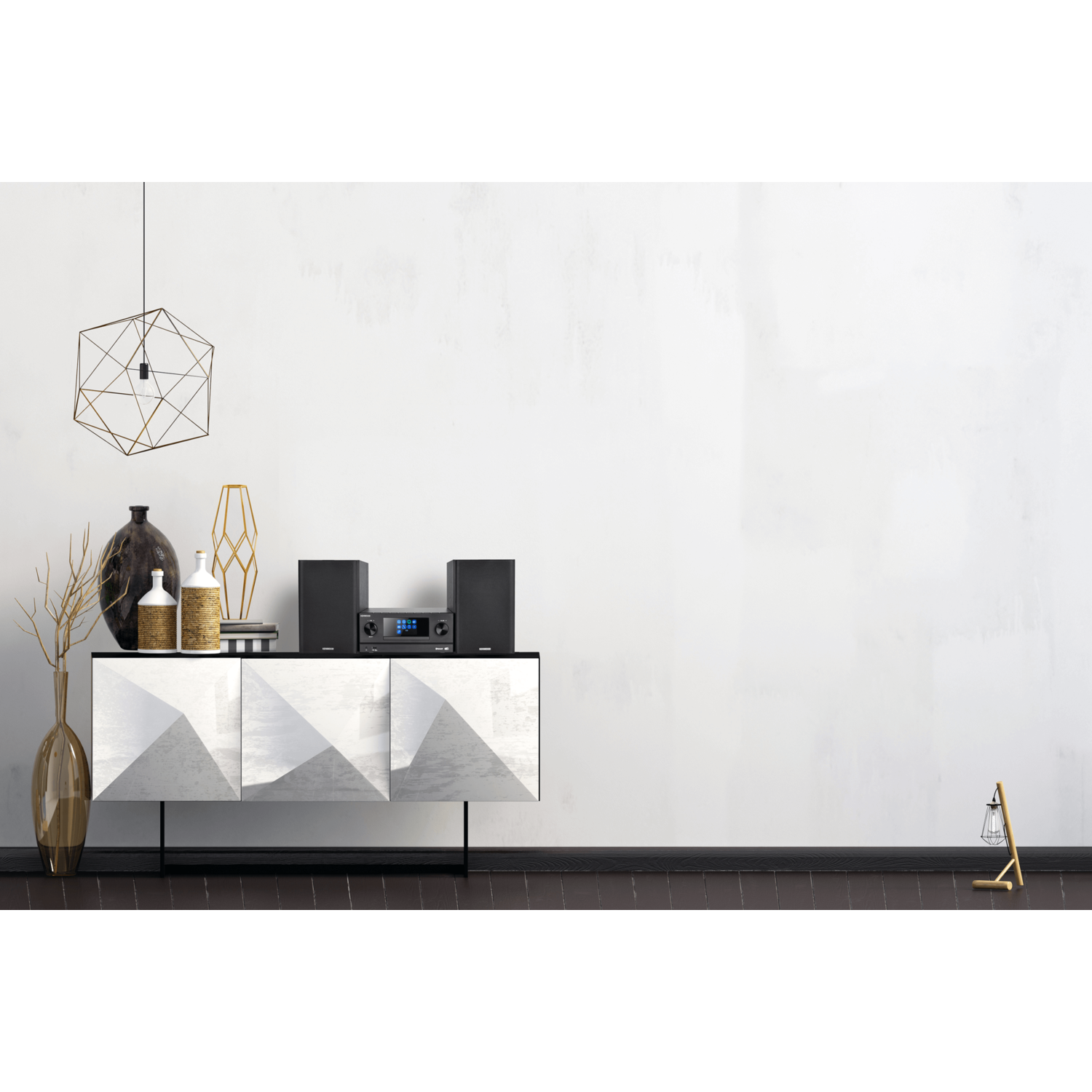 A modern living room setup with a white wall, cabinets and decorations.