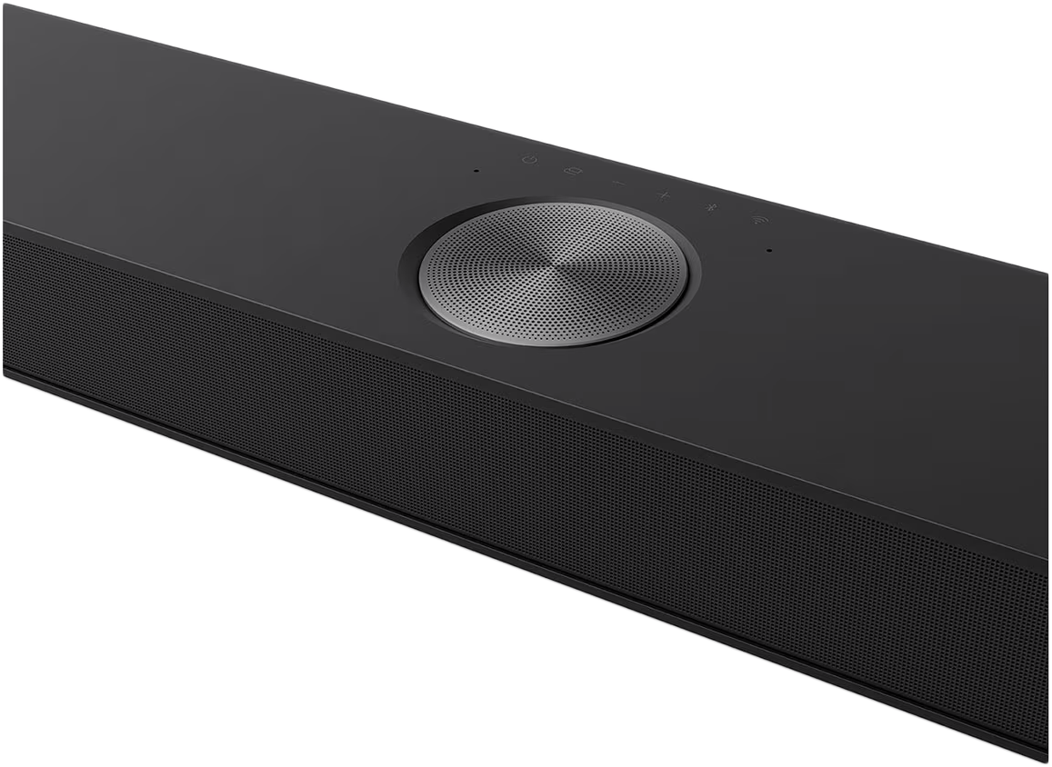 Fekete soundbar. Középen kör alakú rács, tetején vezérlőgombok.
