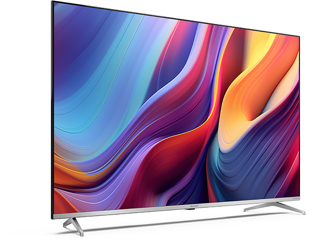 Sharp TV, oldalnézet, színes, absztrakt kijelzővel és ezüst állvánnyal.