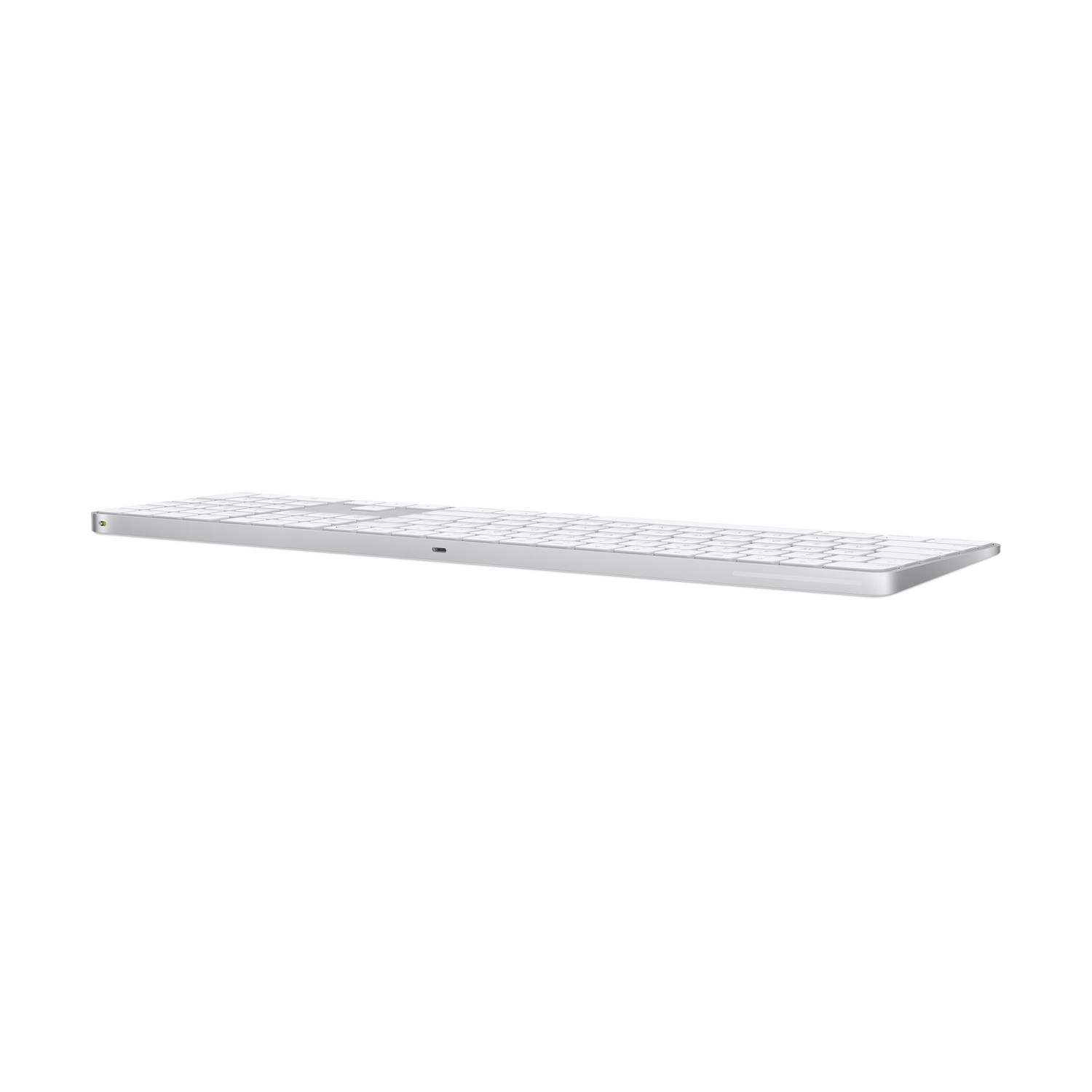 A silver, flat Apple keyboard, seen from a low angle, isolated on white.