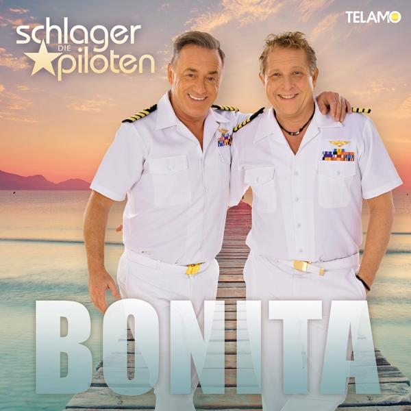 Albumcover mit zwei Männern in weißen Matrosenuniformen, die auf einem Holzsteg stehen.