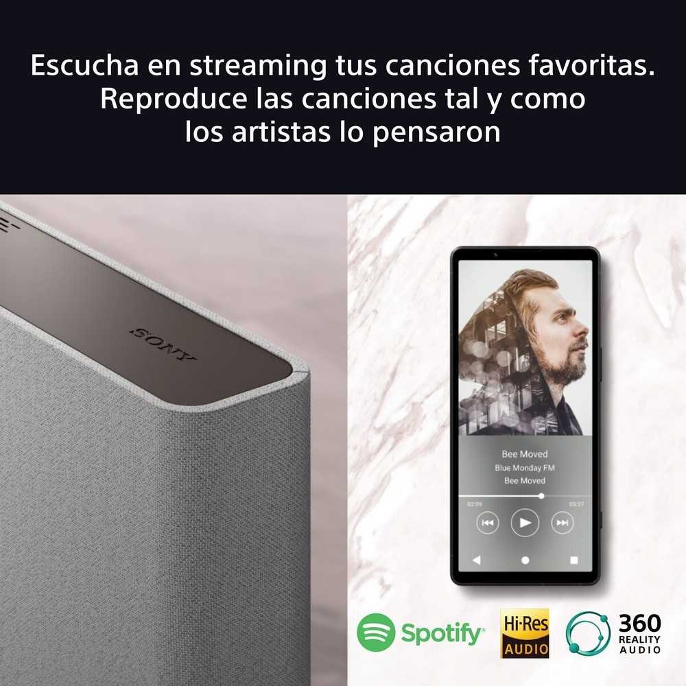 Un altavoz y un teléfono. El teléfono muestra una interfaz de música. El altavoz es gris.