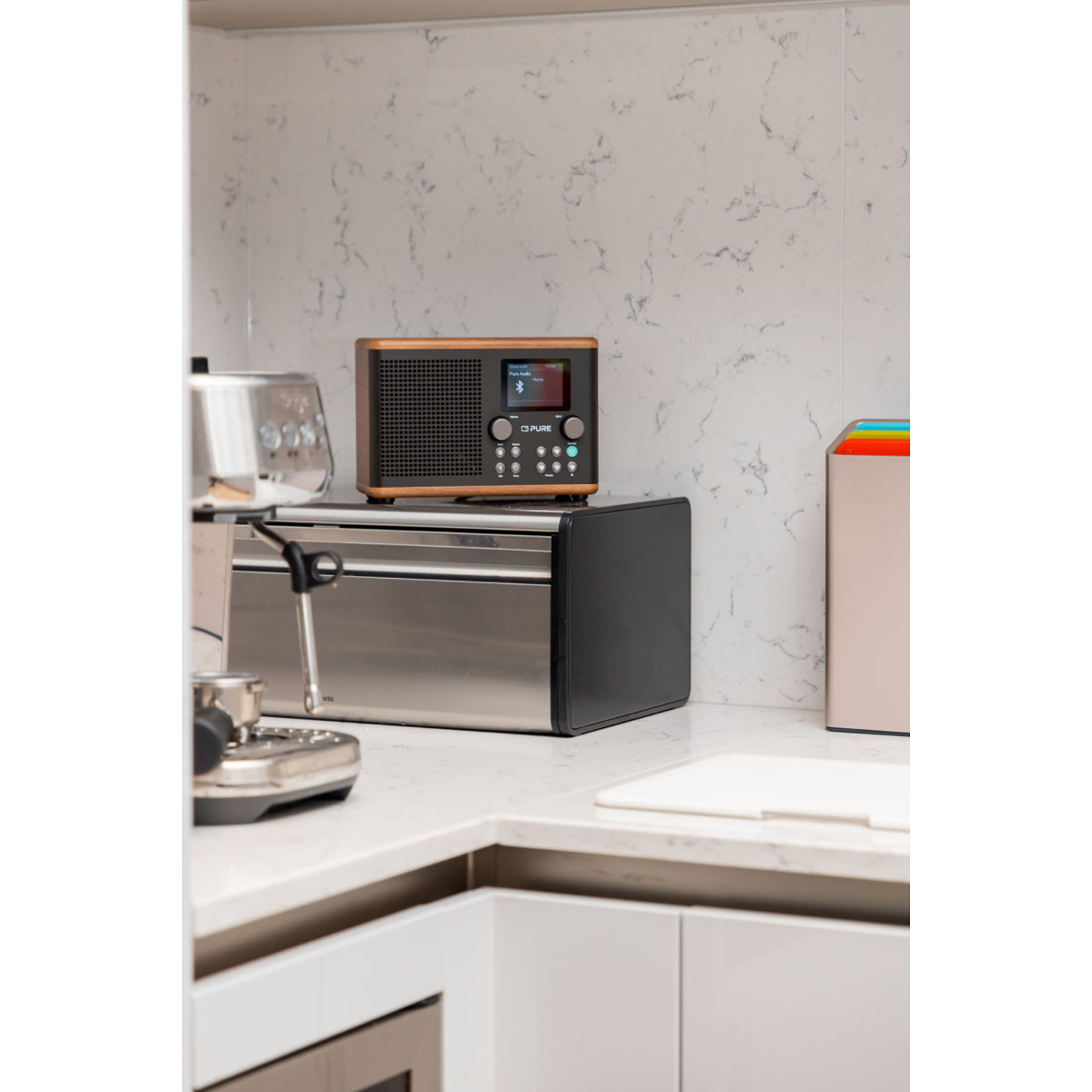 Comptoir de cuisine avec radio, grille-pain et cafetière. La radio est en bois.