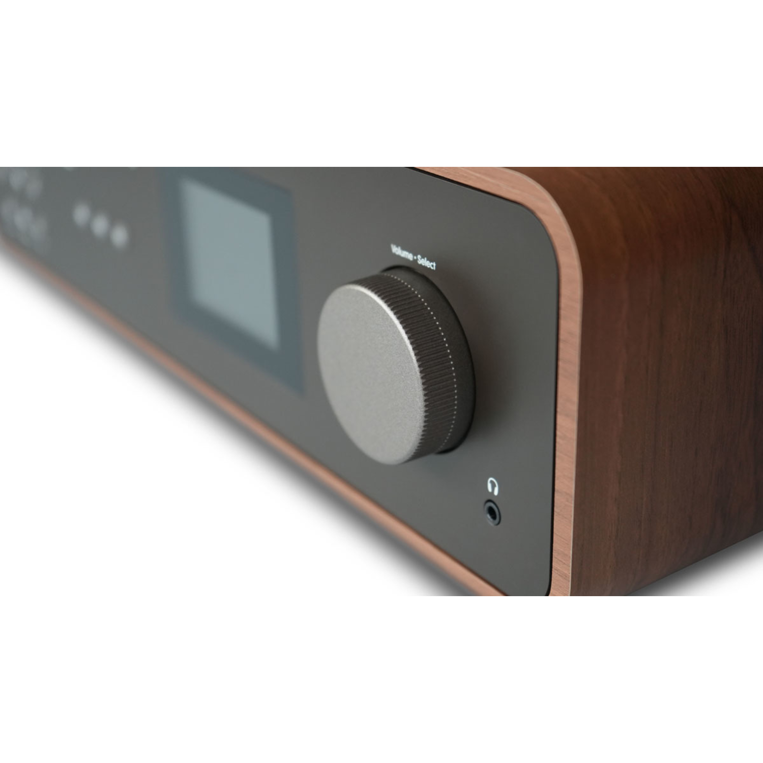 Close-up of a brown wooden radio with a silver volume knob and a small screen.