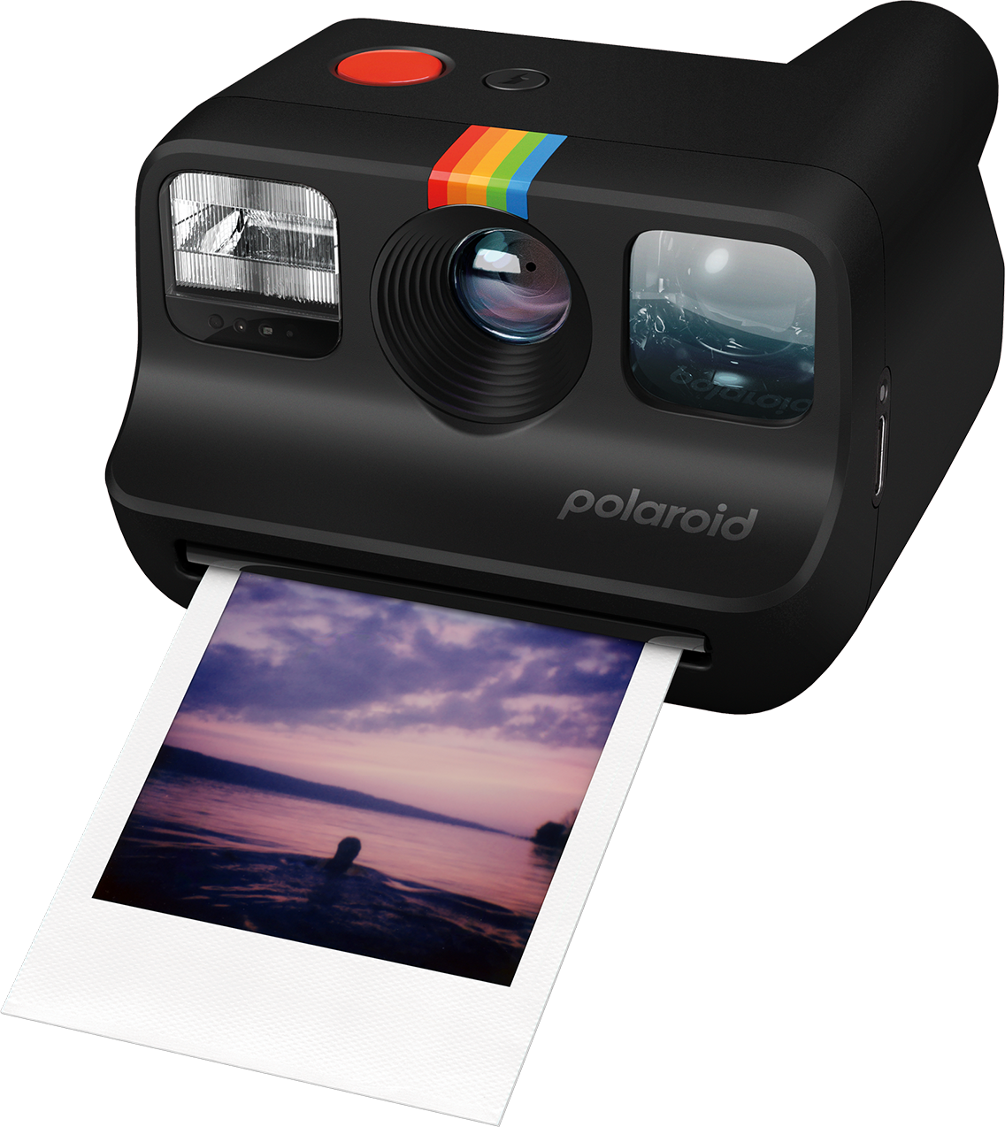 Fotocamera Polaroid nera con una striscia arcobaleno. Una foto sta uscendo.