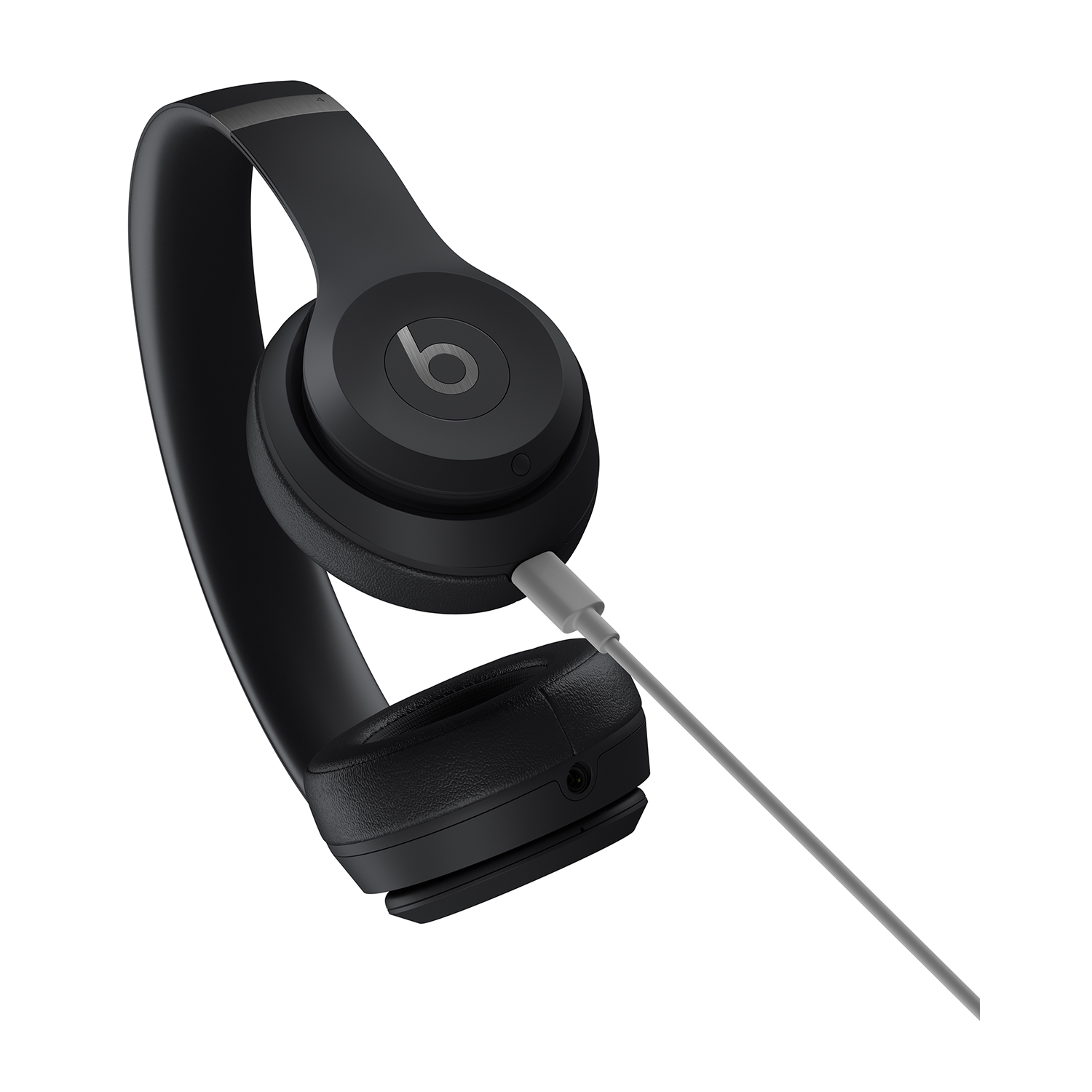 Cuffie Beats nere. Un cavo grigio è collegato. Le cuffie sono su sfondo bianco.