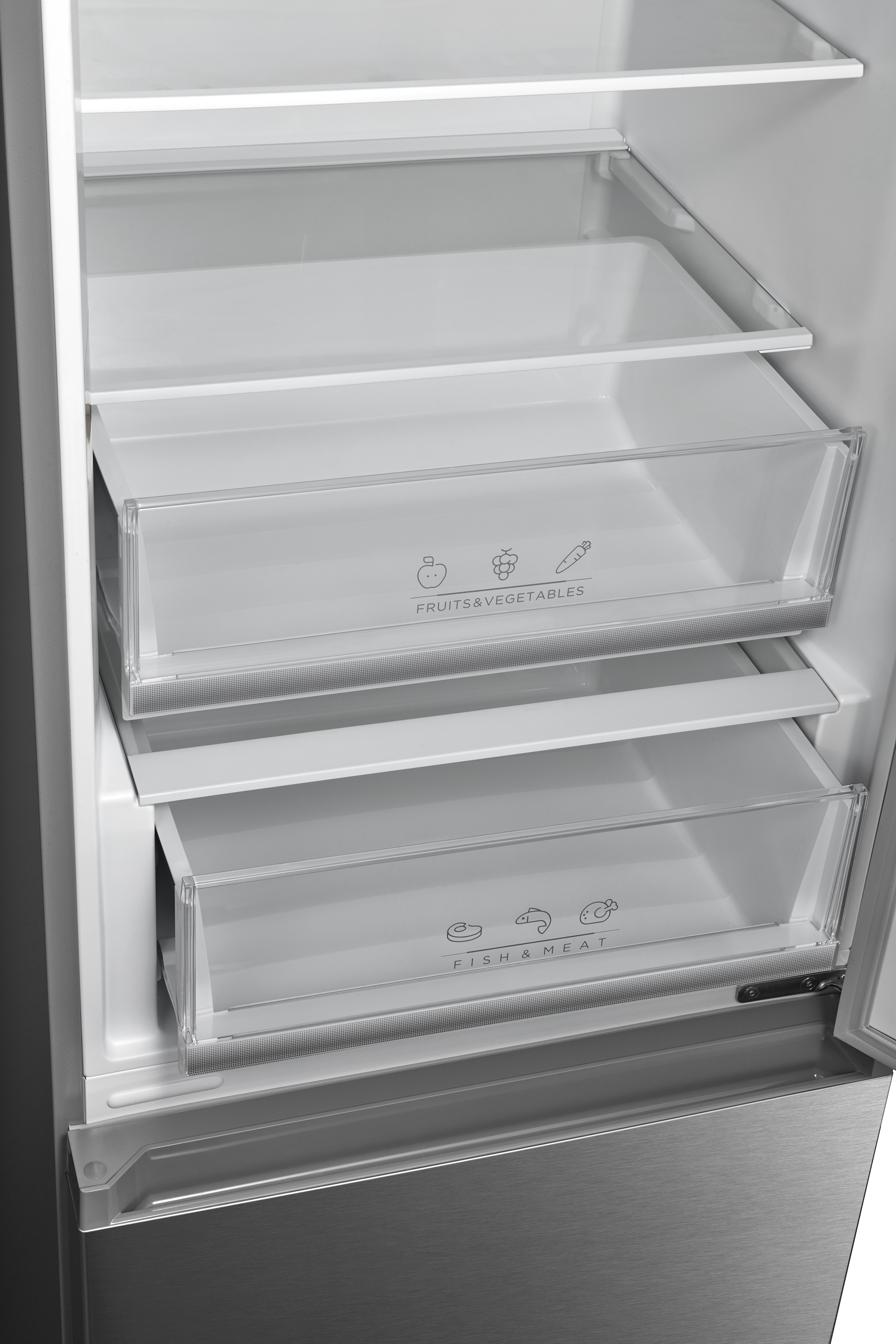 Innenraum eines Kühlschranks mit Schubladen mit der Aufschrift 'FRÜCHTE & GEMÜSE' und 'FISCH & FLEISCH'.