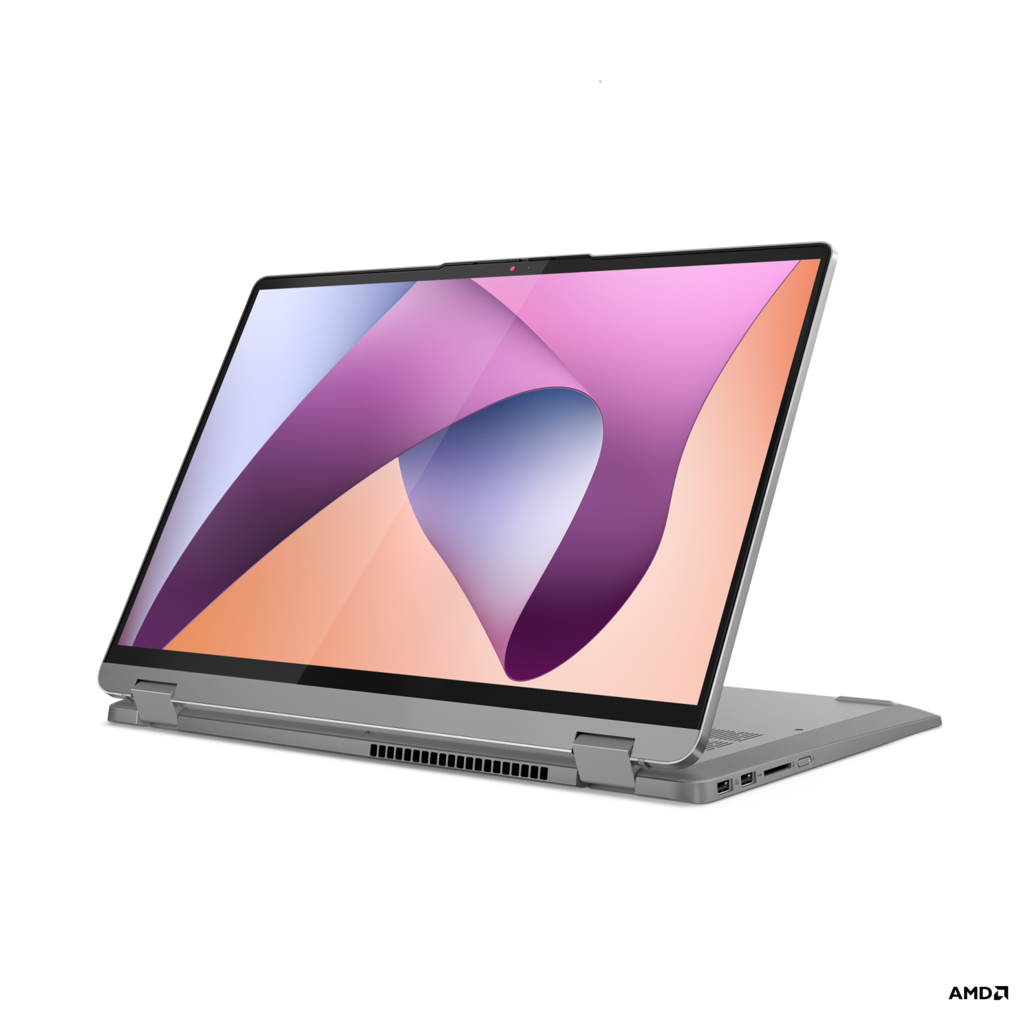 A silver laptop, open, with a colorful abstract wallpaper on the screen, against a black background.