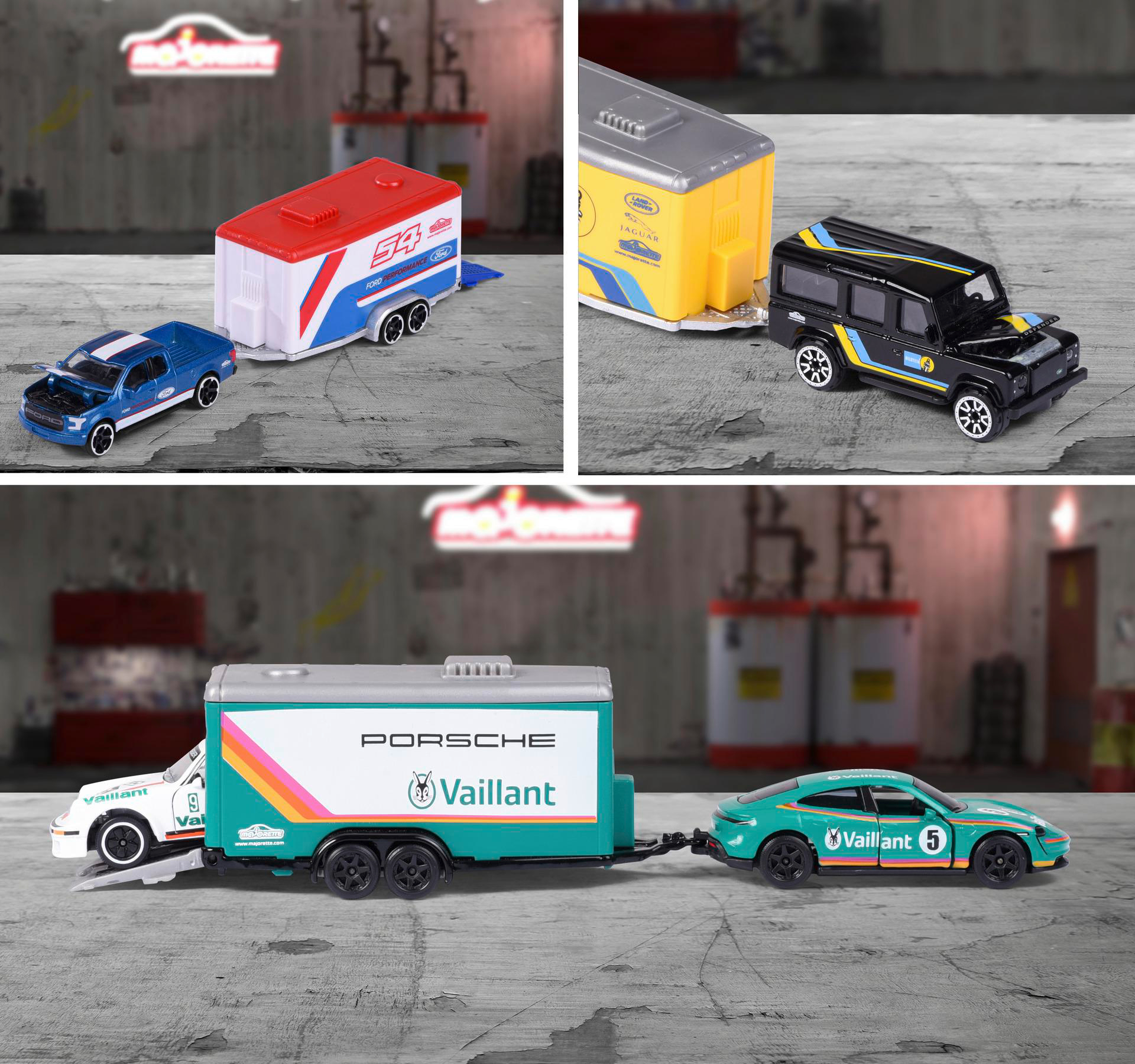Spielzeugautos mit Anhängern, verschiedene Farben, auf grauem Untergrund.
