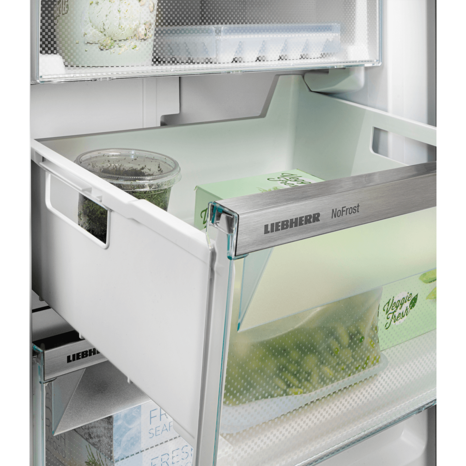 Inside a refrigerator, a drawer with food items and a label.