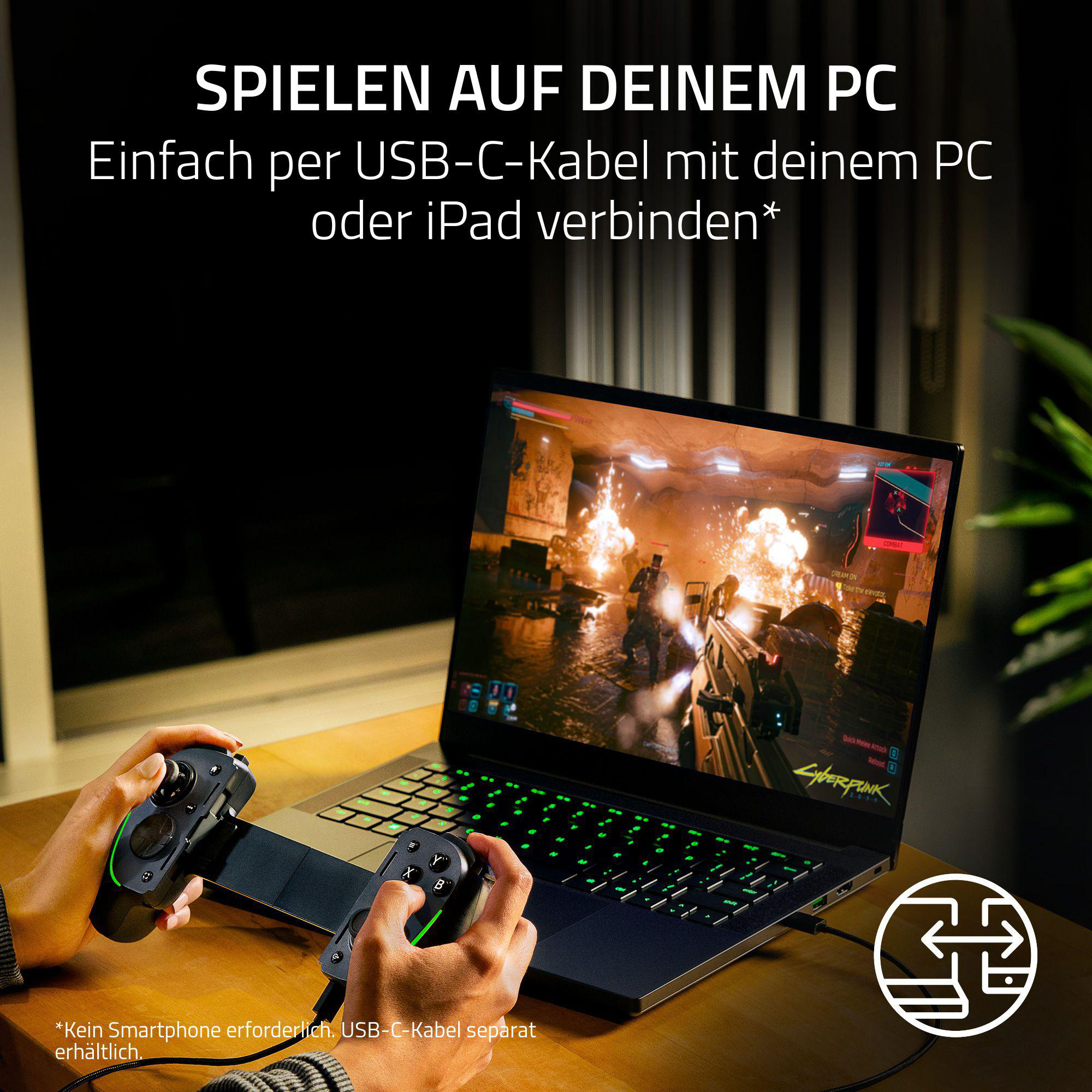 Eine Person spielt ein Spiel auf einem Laptop, mit einem Controller in der Hand.