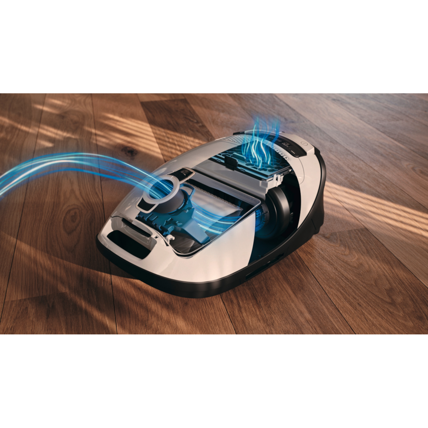 A white and black vacuum cleaner showing internal components with blue highlighted air flow, on wood flooring.