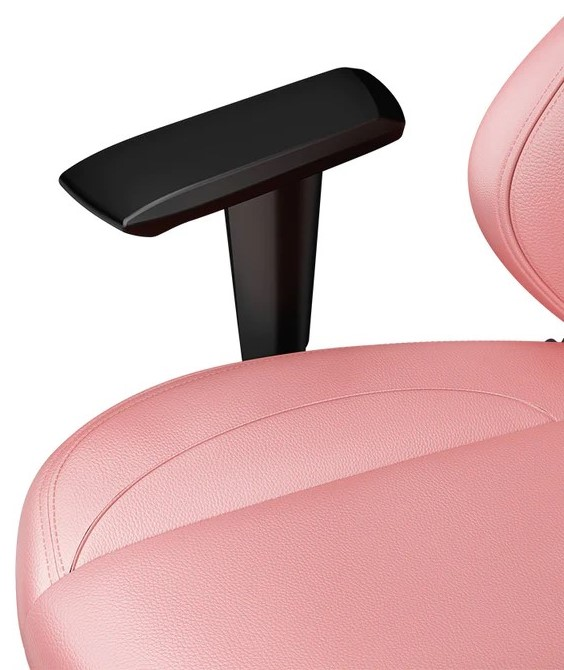 Primo piano di un bracciolo e sedile di una sedia rosa. Il bracciolo è nero.