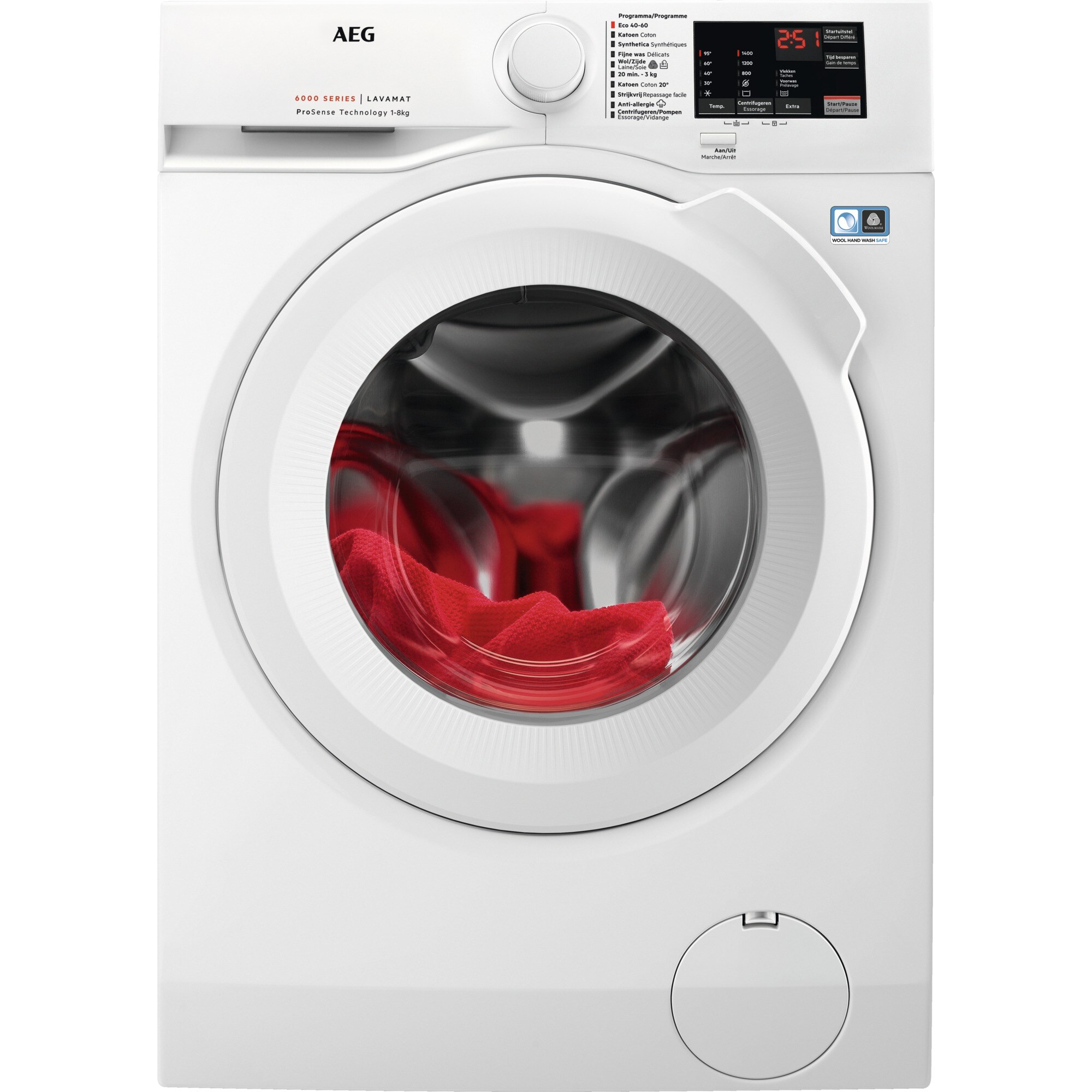 White washing machine with red laundry inside the drum, front view.