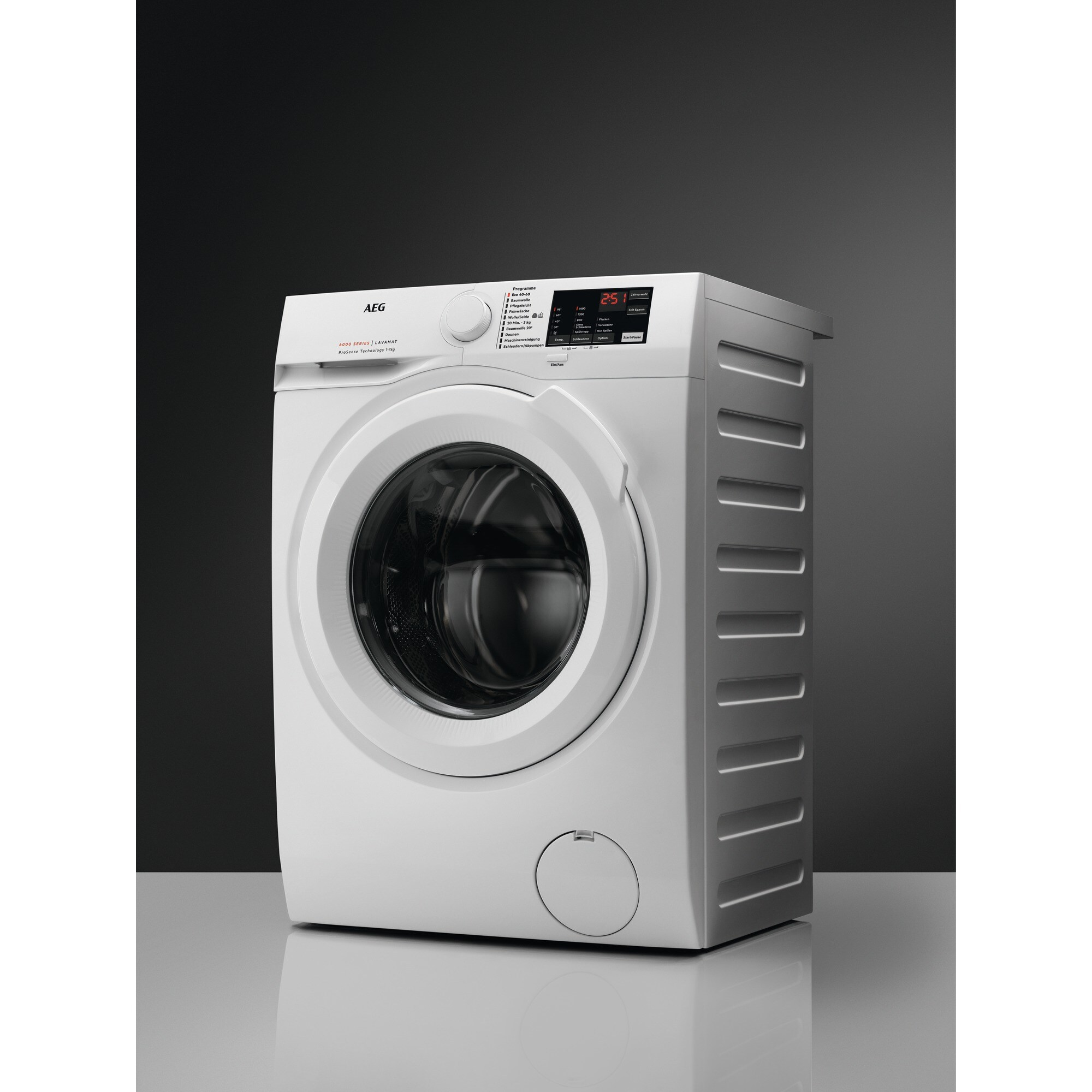 White AEG washing machine on a reflective surface. The background is dark gray.