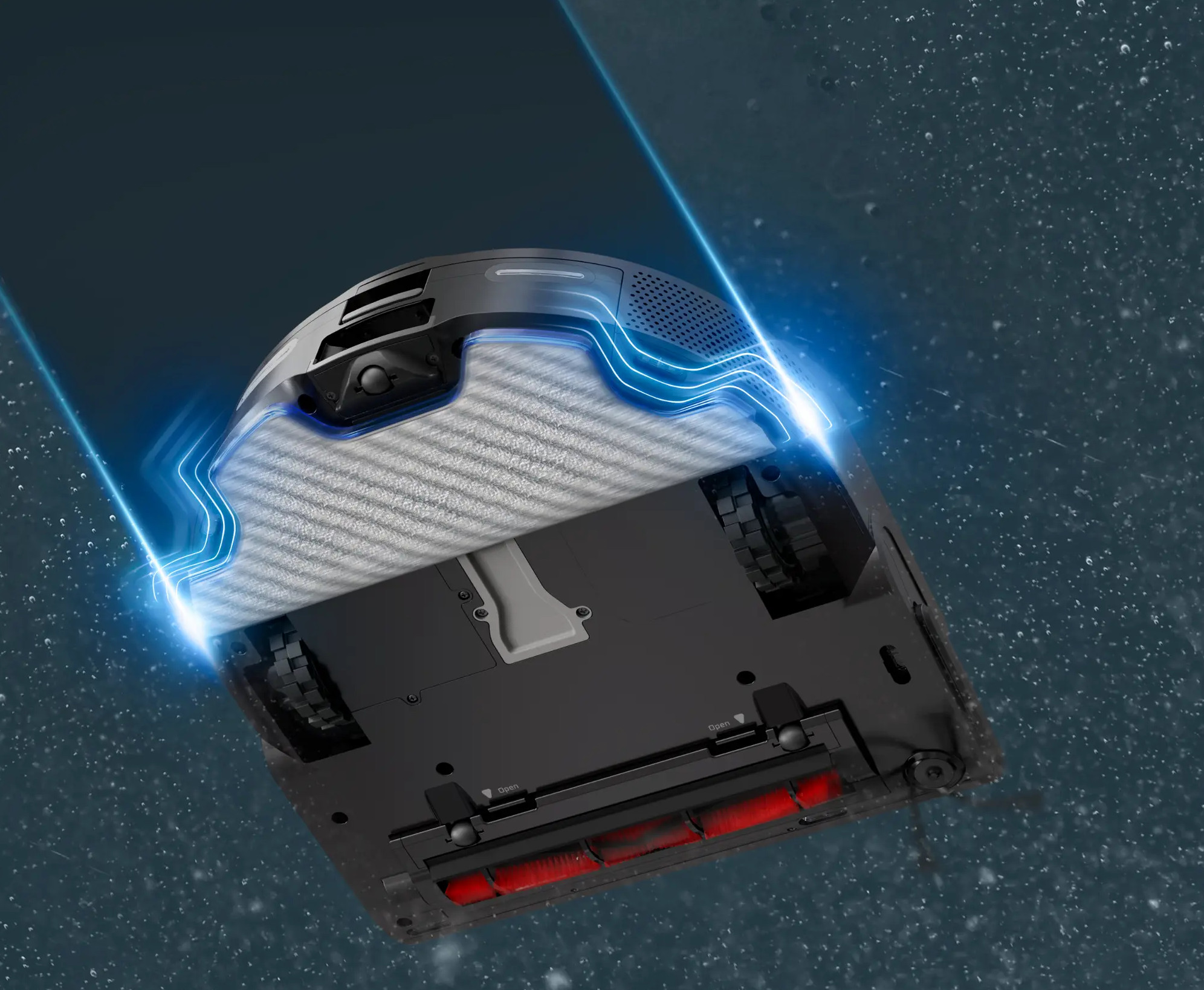 Robot odkurzający, widok od spodu, ze szczotką i kołami. Niebieskie smugi światła.