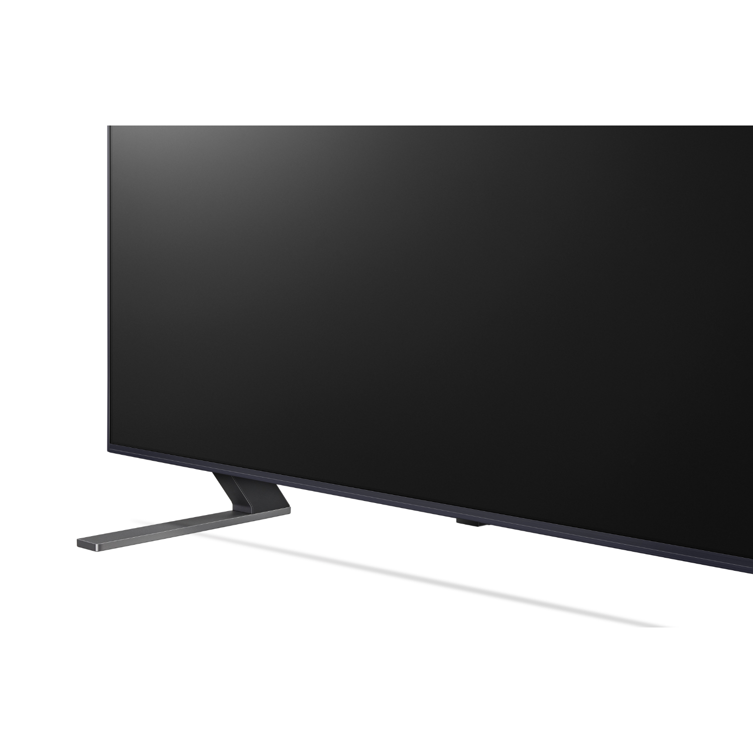 Large black TV. The screen is dark, with a silver stand on a white background.