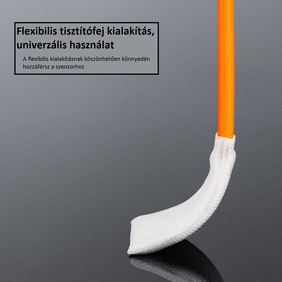 Egy tisztítóeszköz közeli képe. Az eszköz narancssárga szárral és fehér tisztítófelülettel rendelkezik. A háttér sötét.