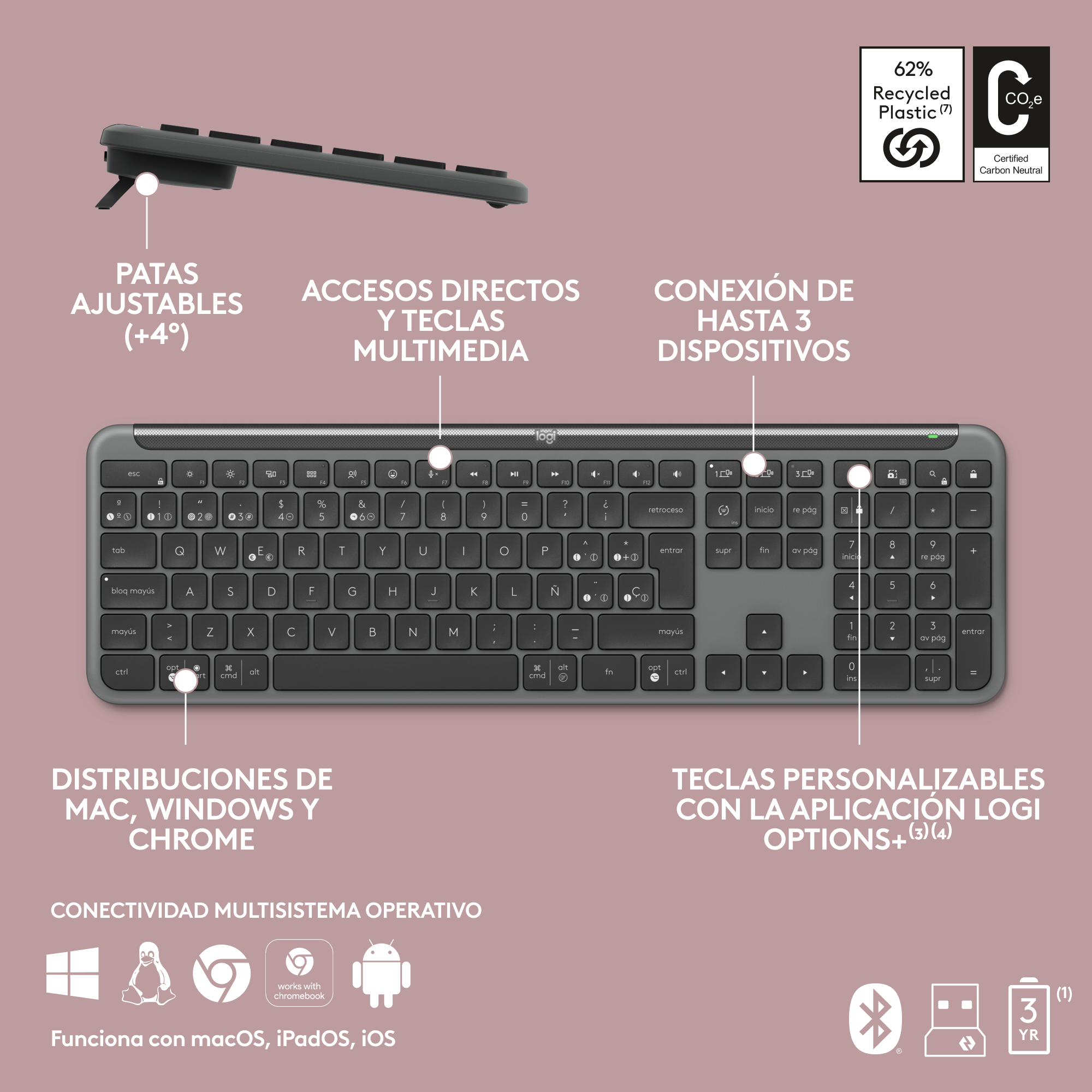 Un teclado gris con patas ajustables, teclas multimedia e iconos de conectividad multisistema.