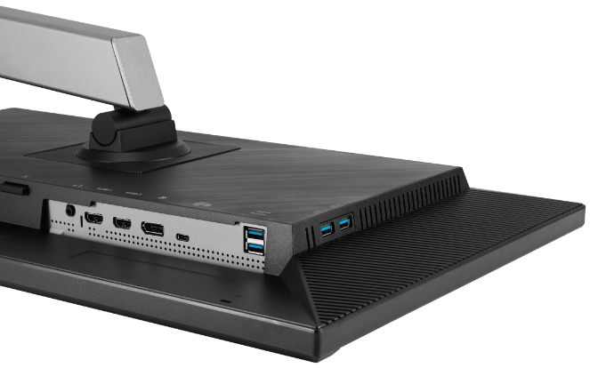 Tył monitora z widocznymi portami. Posiada srebrne ramię i czarny, teksturowany panel tylny.