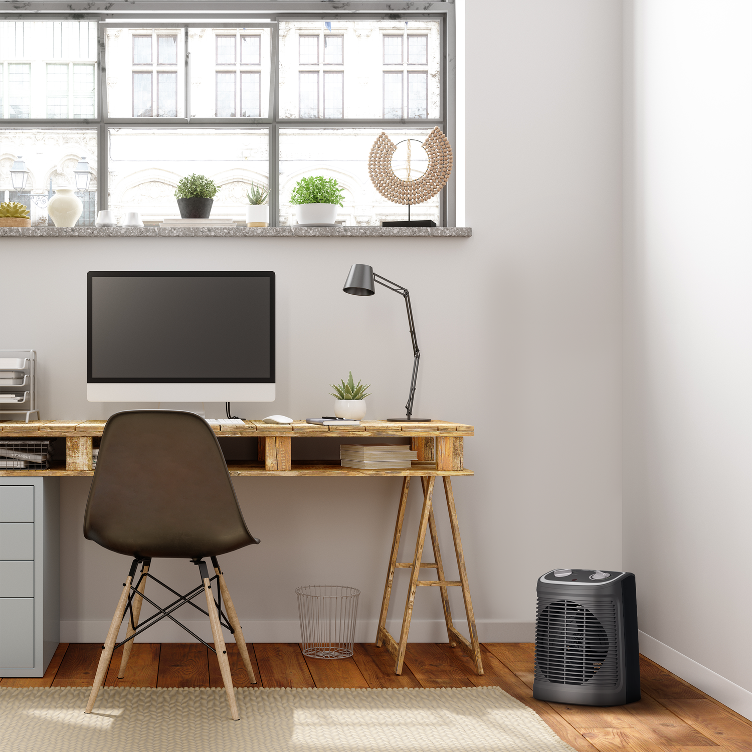 Home office scene. Desk with computer, chair, lamp and a space heater.